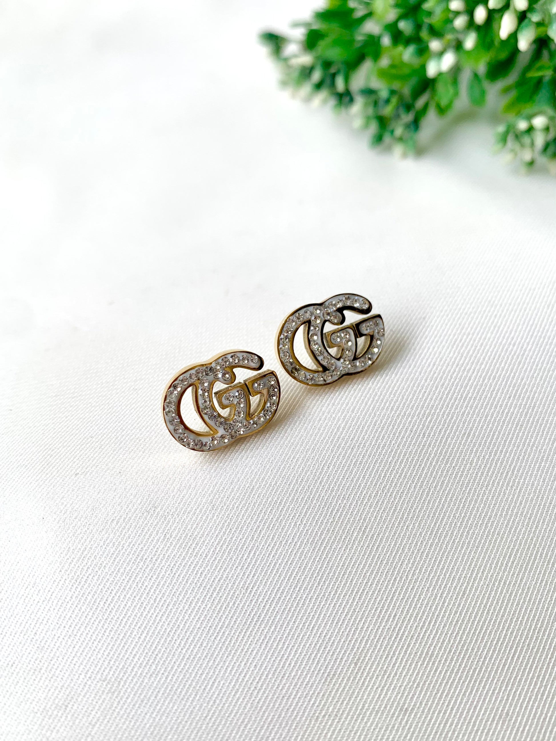 Gleia crystal gold studs with double-G design, 22K gold plated on 316L stainless steel by Zamal Jewels.