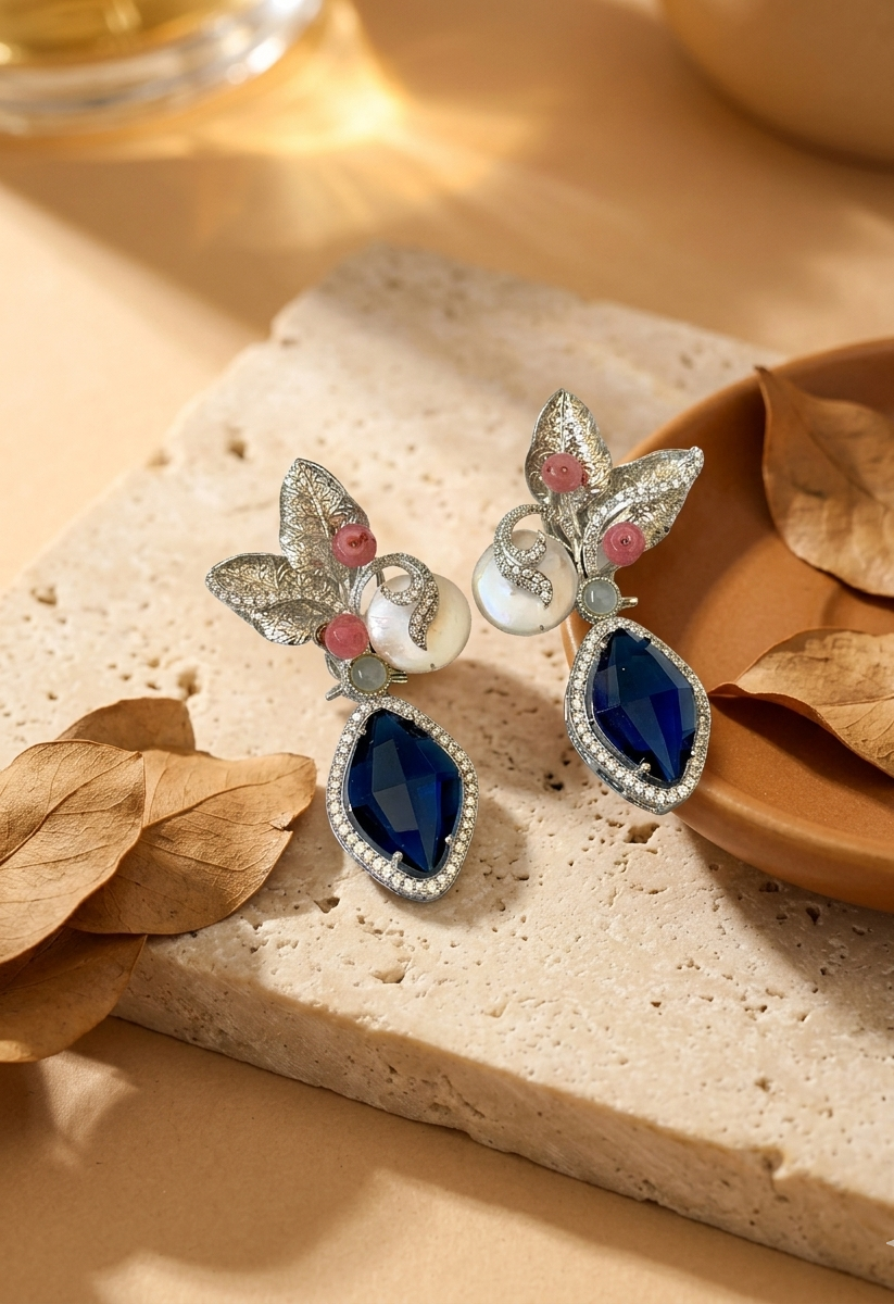 Krisha designer earrings in rhodium foil finish with baroque pearls, sapphire and onyx gemstones