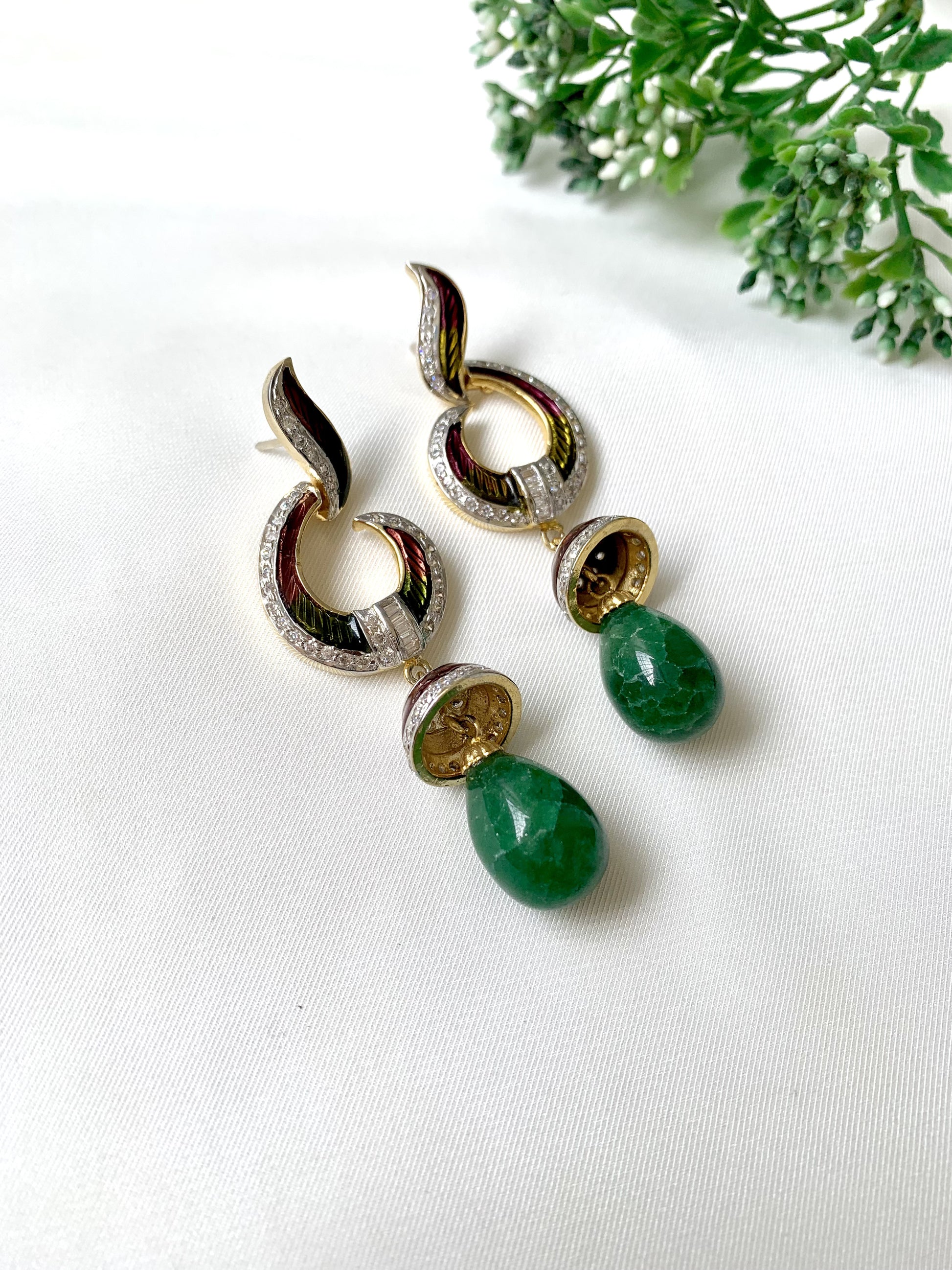 Handcrafted emerald jhumka earrings with American Diamonds and hand-painted Meena detailing in gold-tone finish