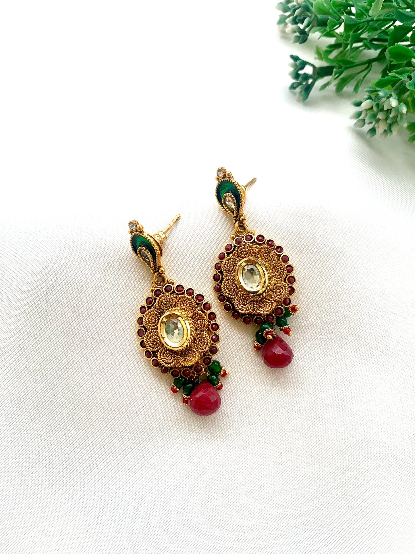 Navina handcrafted 22kt gold plated earrings featuring authentic Kundan, semi-precious Ruby, and hand-painted Meena