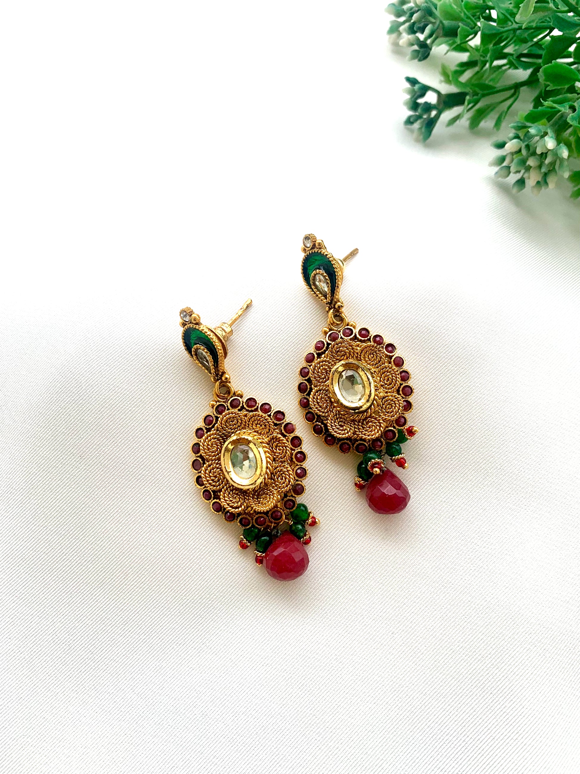 Navina handcrafted 22kt gold plated earrings featuring authentic Kundan, semi-precious Ruby, and hand-painted Meena