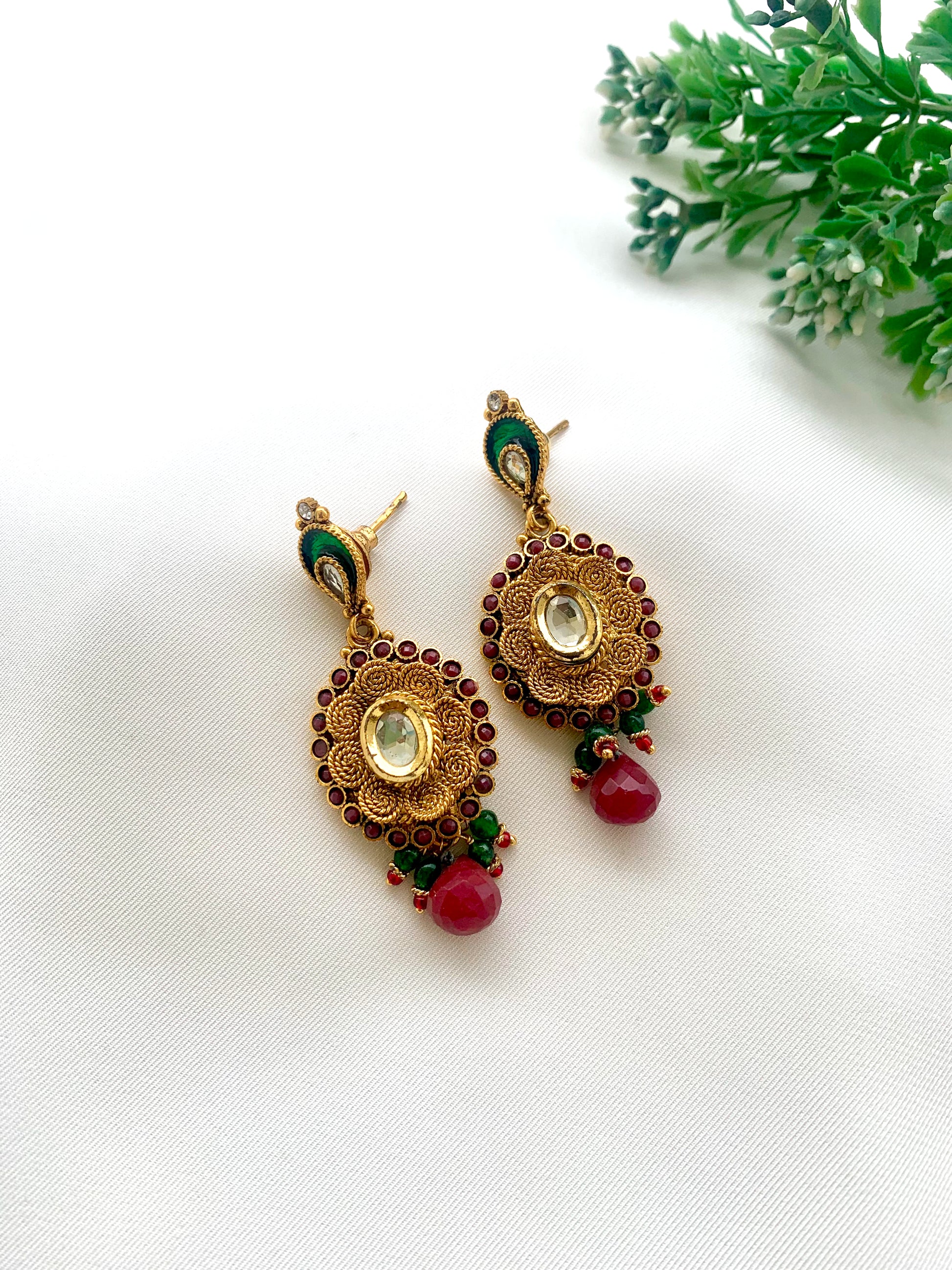 Navina handcrafted 22kt gold plated earrings featuring authentic Kundan, semi-precious Ruby, and hand-painted Meena