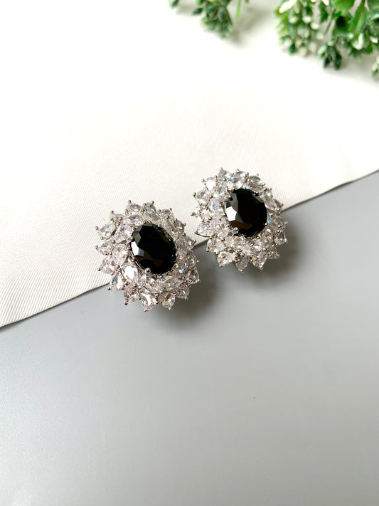 Handcrafted rhodium plated stud earrings with platinum finish, featuring semi-precious onyx center and American Diamonds