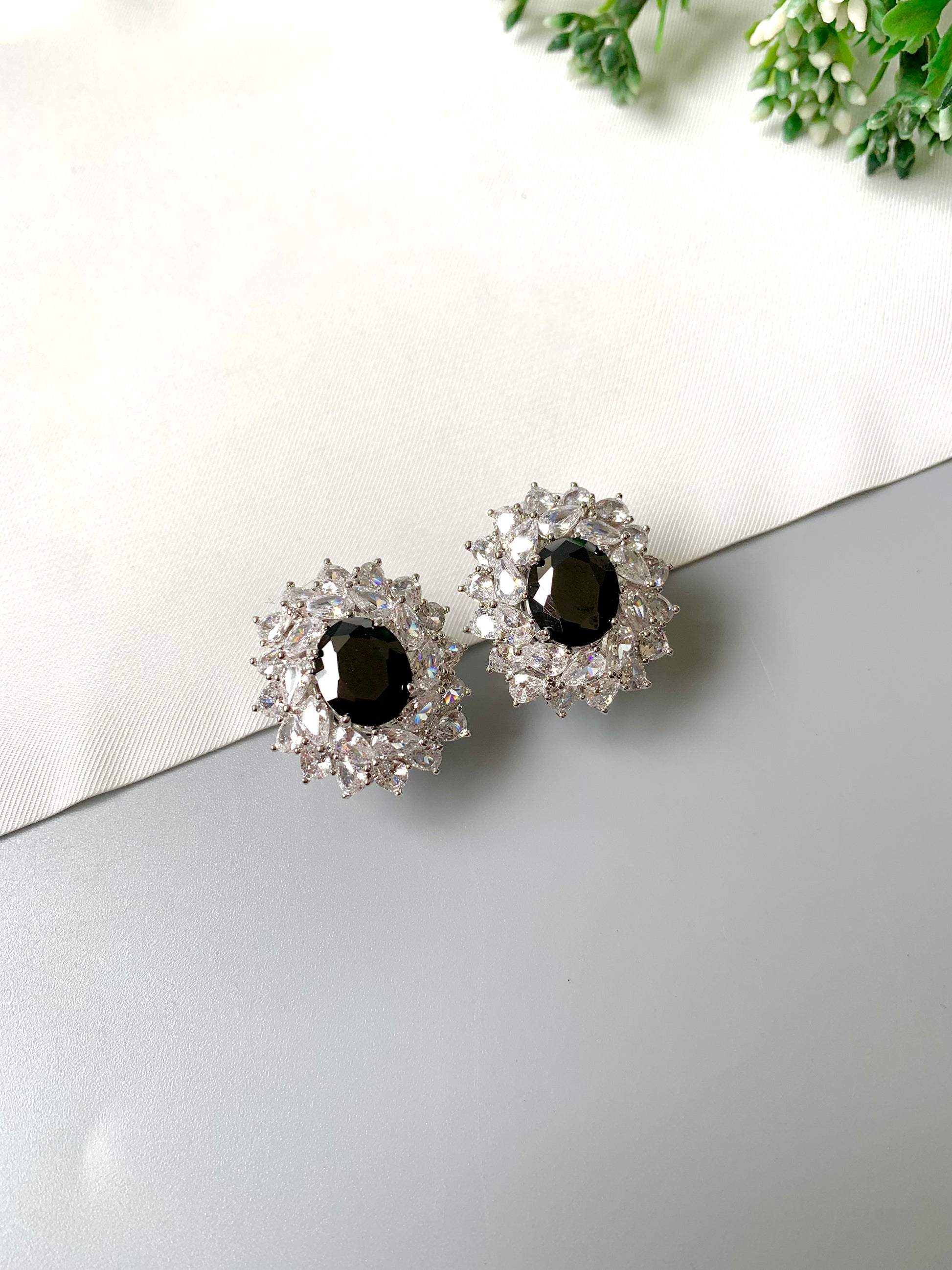 Close-up angled view of rhodium plated onyx and American Diamond stud earrings, luxury handcrafted jewelry