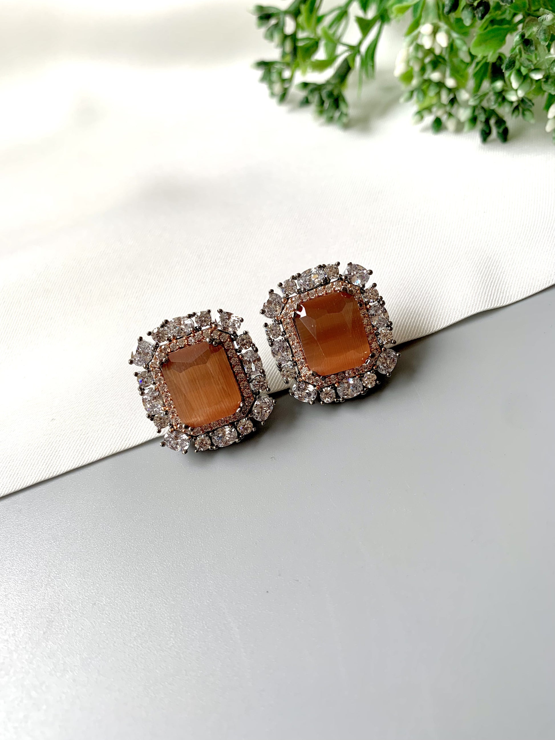 Luxury Onyx and American Diamond studs in dual-tone 22kt gold and oxidized rhodium, angled display