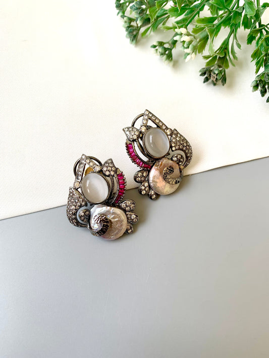 Handcrafted oxidized rhodium studs with real baroque pearls, rubies, and American diamonds by Zamal Jewels.