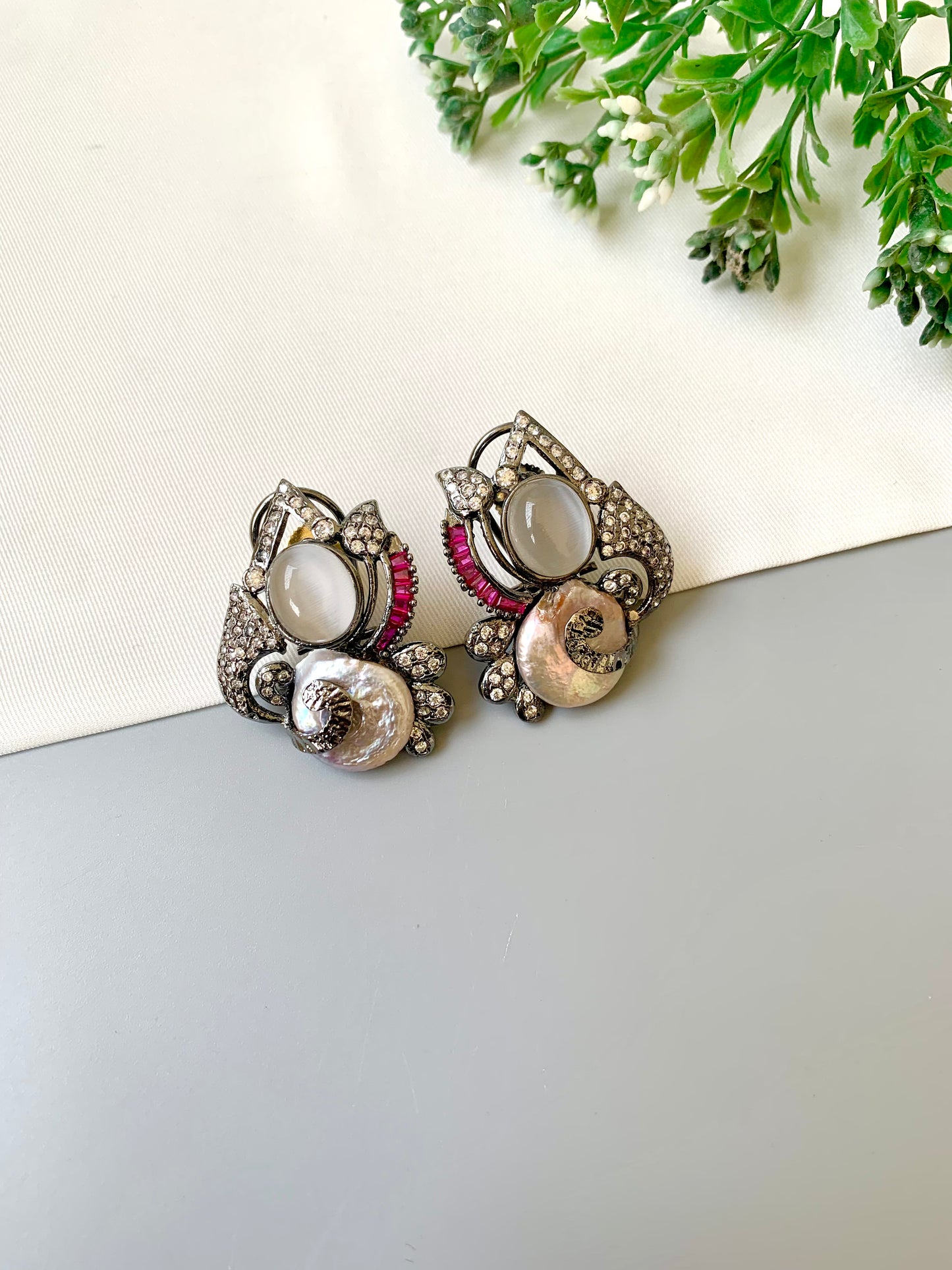 Handcrafted oxidized rhodium studs with real baroque pearls, rubies, and American diamonds by Zamal Jewels.