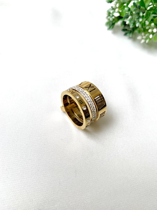 Roma gold ring set with Roman numeral engravings and crystal accents, 22K gold plated on 316L stainless steel by Zamal Jewels.