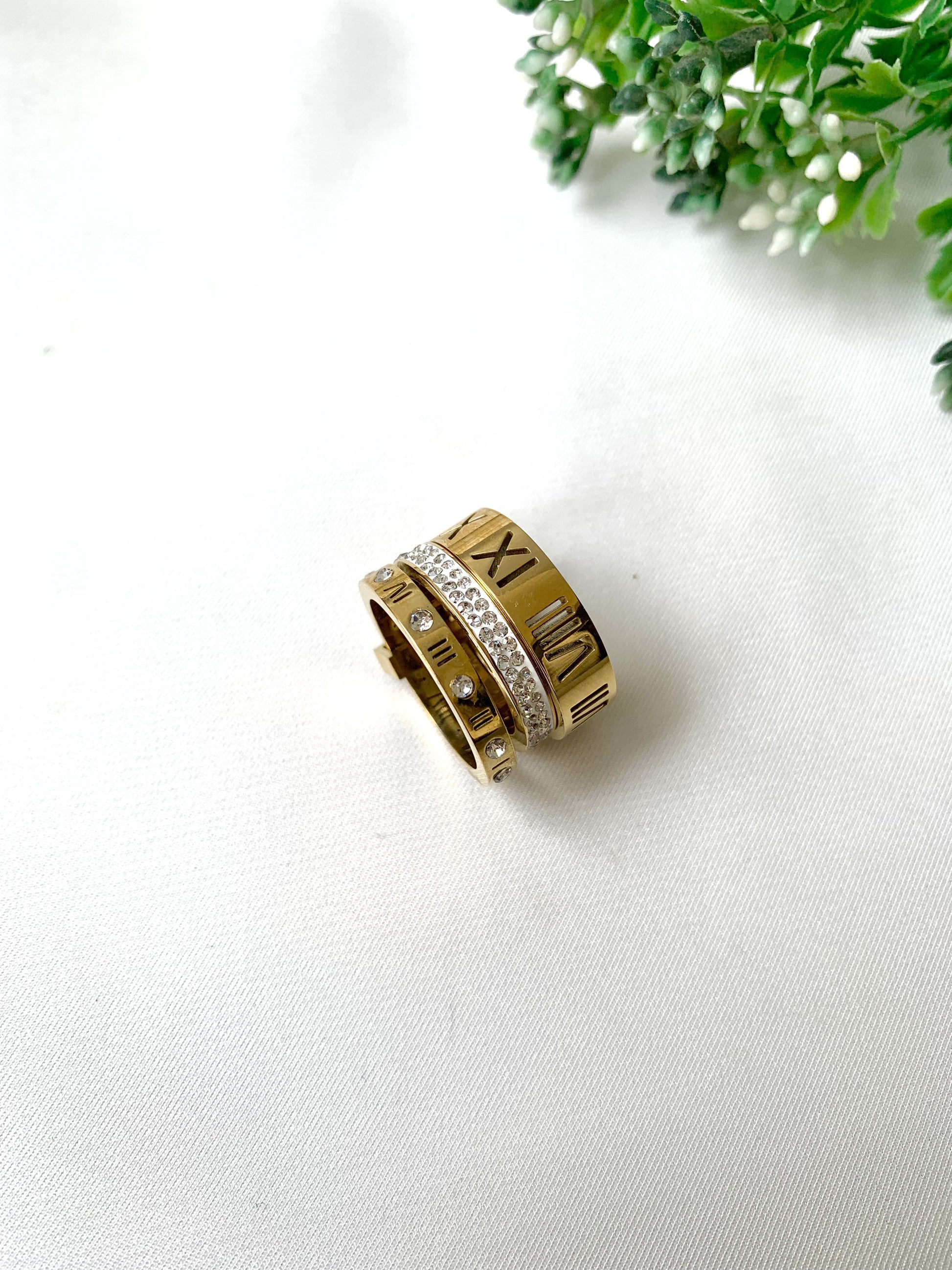 Roma gold ring set with Roman numeral engravings and crystal accents, 22K gold plated on 316L stainless steel by Zamal Jewels.