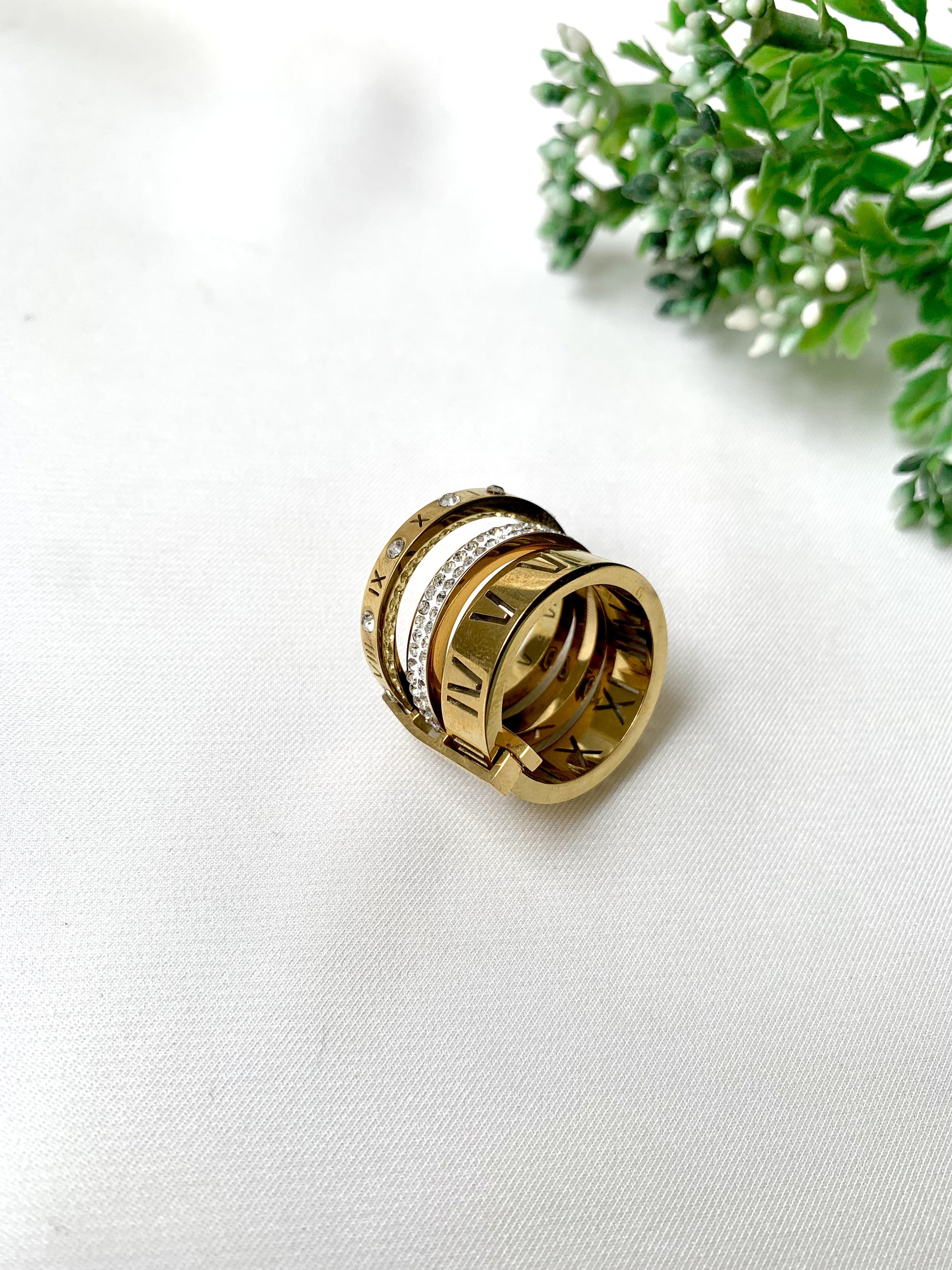 Roma gold ring set with Roman numeral engravings and crystal accents, 22K gold plated on 316L stainless steel by Zamal Jewels.