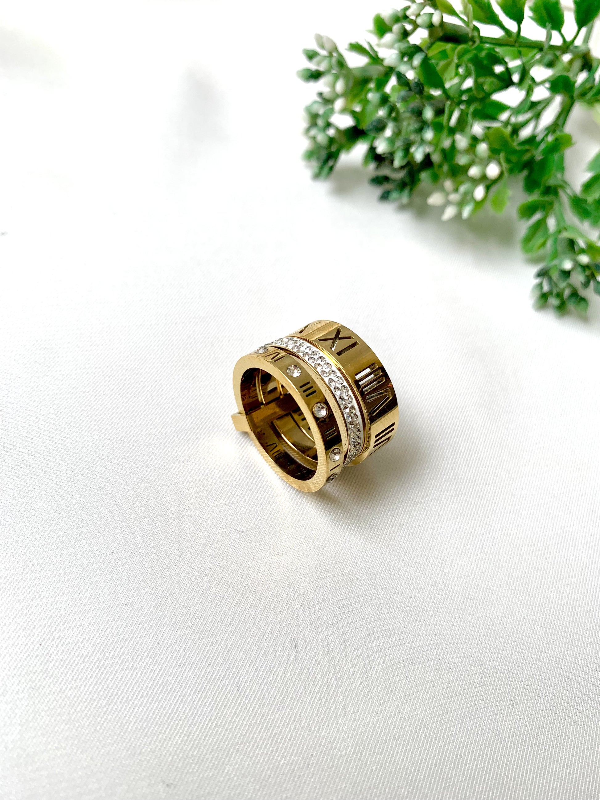 Roma gold ring set with Roman numeral engravings and crystal accents, 22K gold plated on 316L stainless steel by Zamal Jewels.