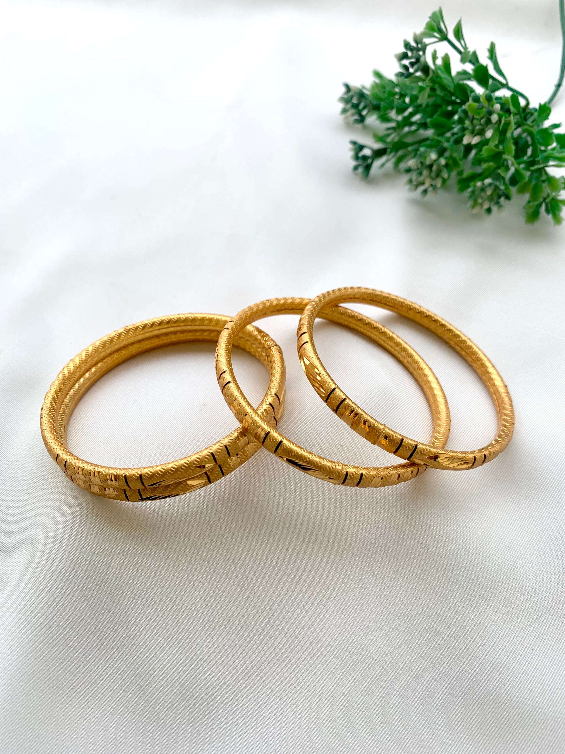 Shehla handcrafted lightweight 22kt gold plated bangles sold as a set of four and available in sizes 2.4, 2.6, and 2.8