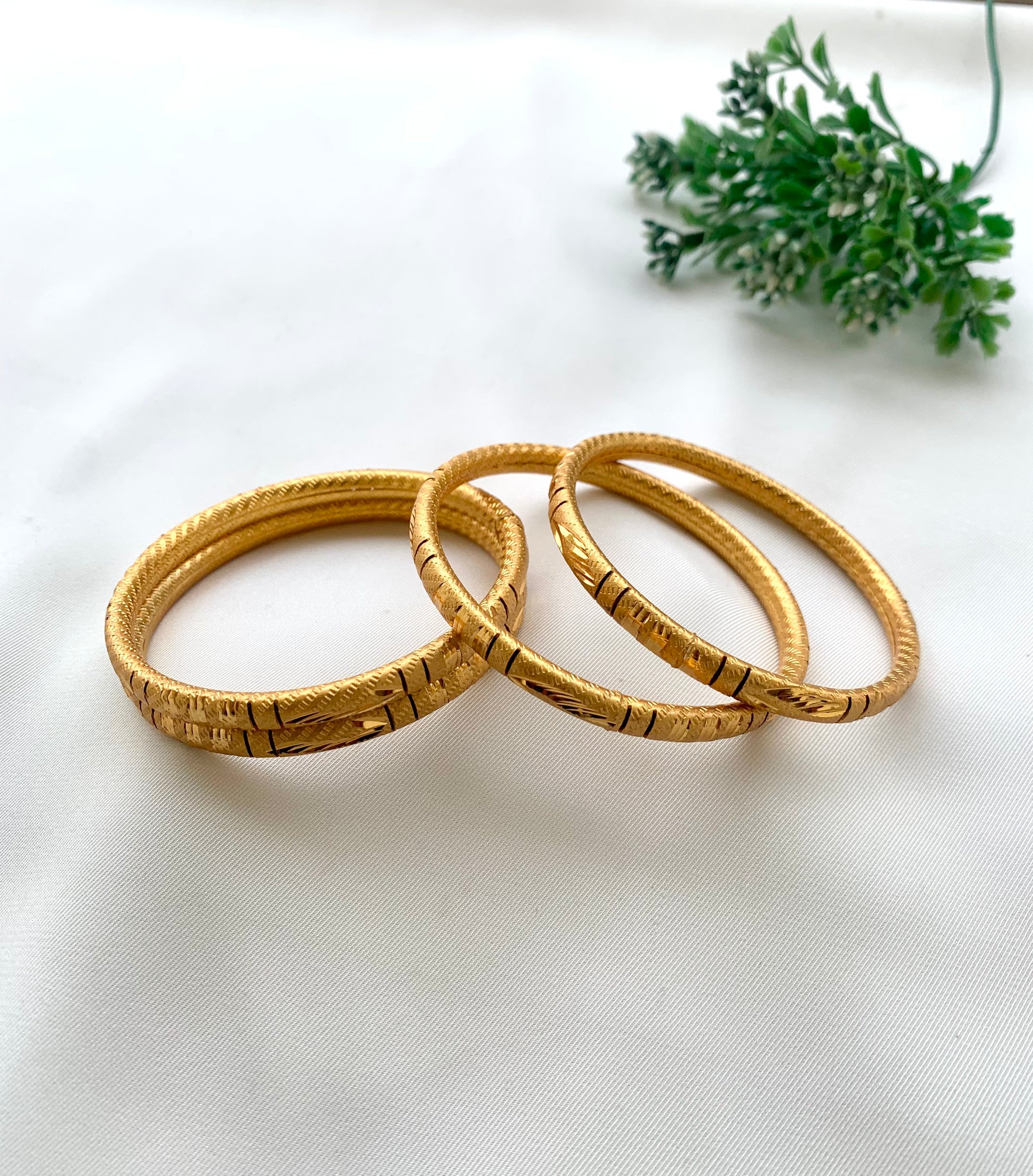 Shehla handcrafted lightweight 22kt gold plated bangles sold as a set of four and available in sizes 2.4, 2.6, and 2.8