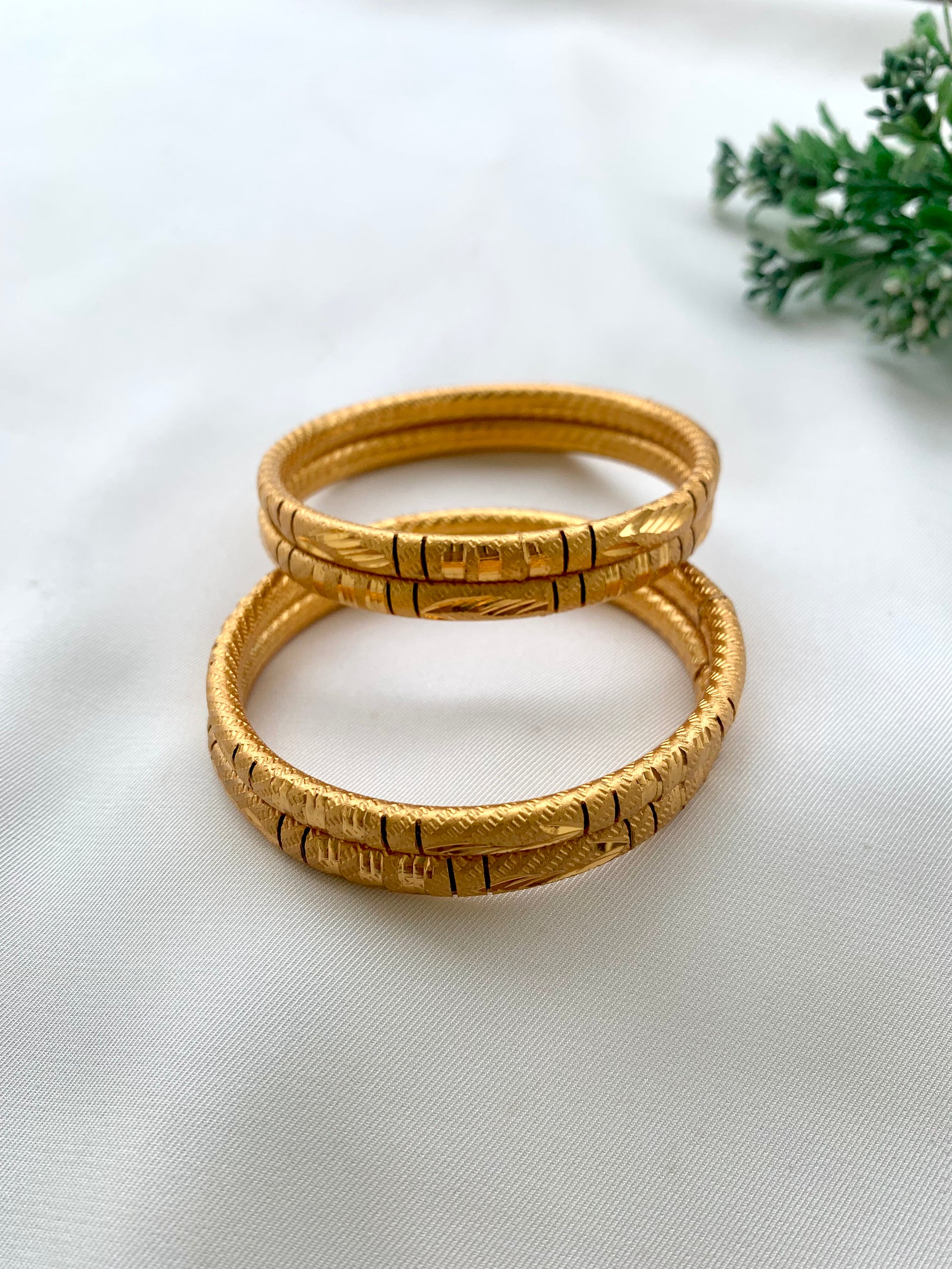 Shehla handcrafted lightweight 22kt gold plated bangles sold as a set of four and available in sizes 2.4, 2.6, and 2.8
