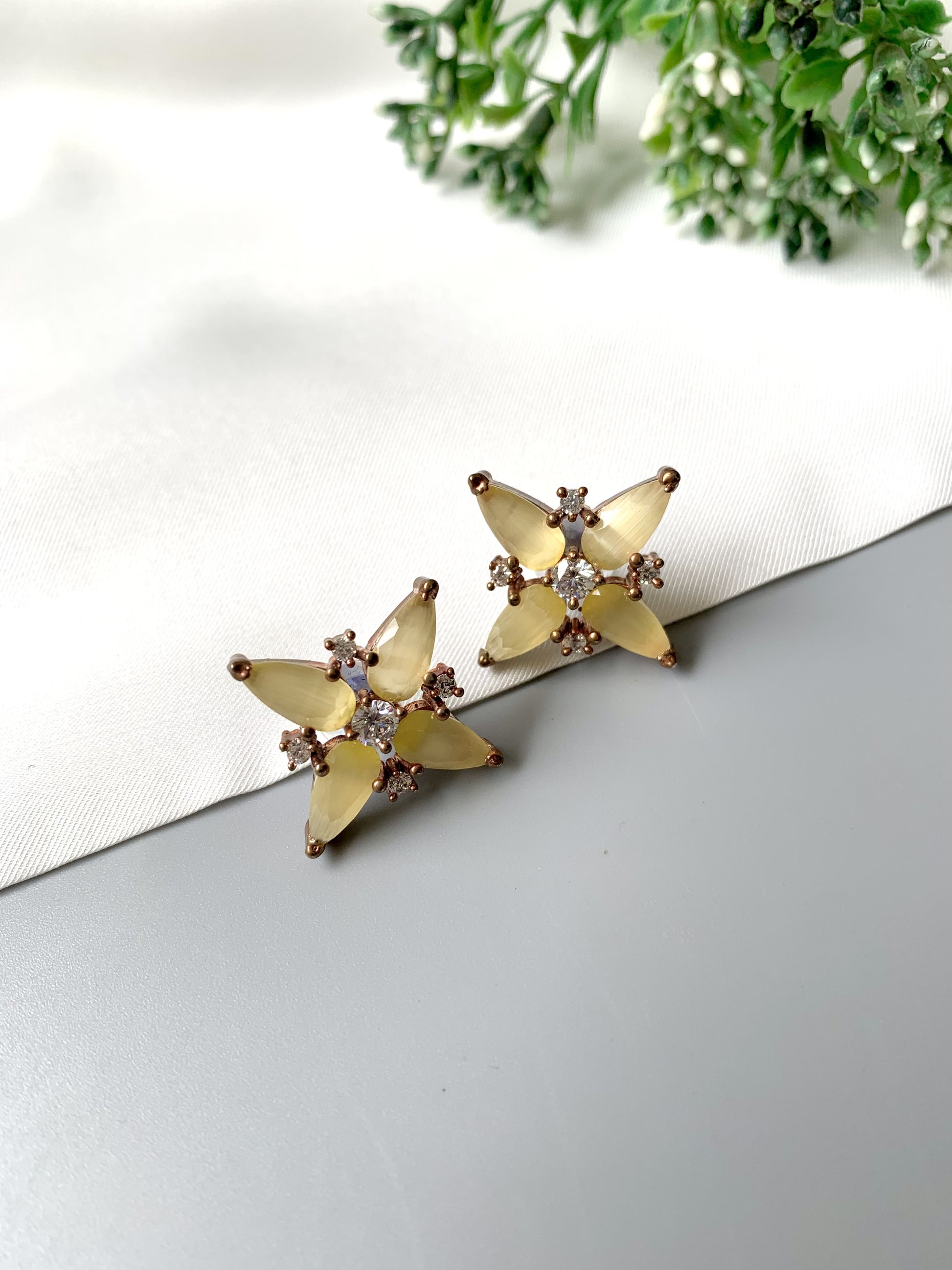 Pair of Sunlit Bloom Studs featuring marquise yellow stones and diamond accents