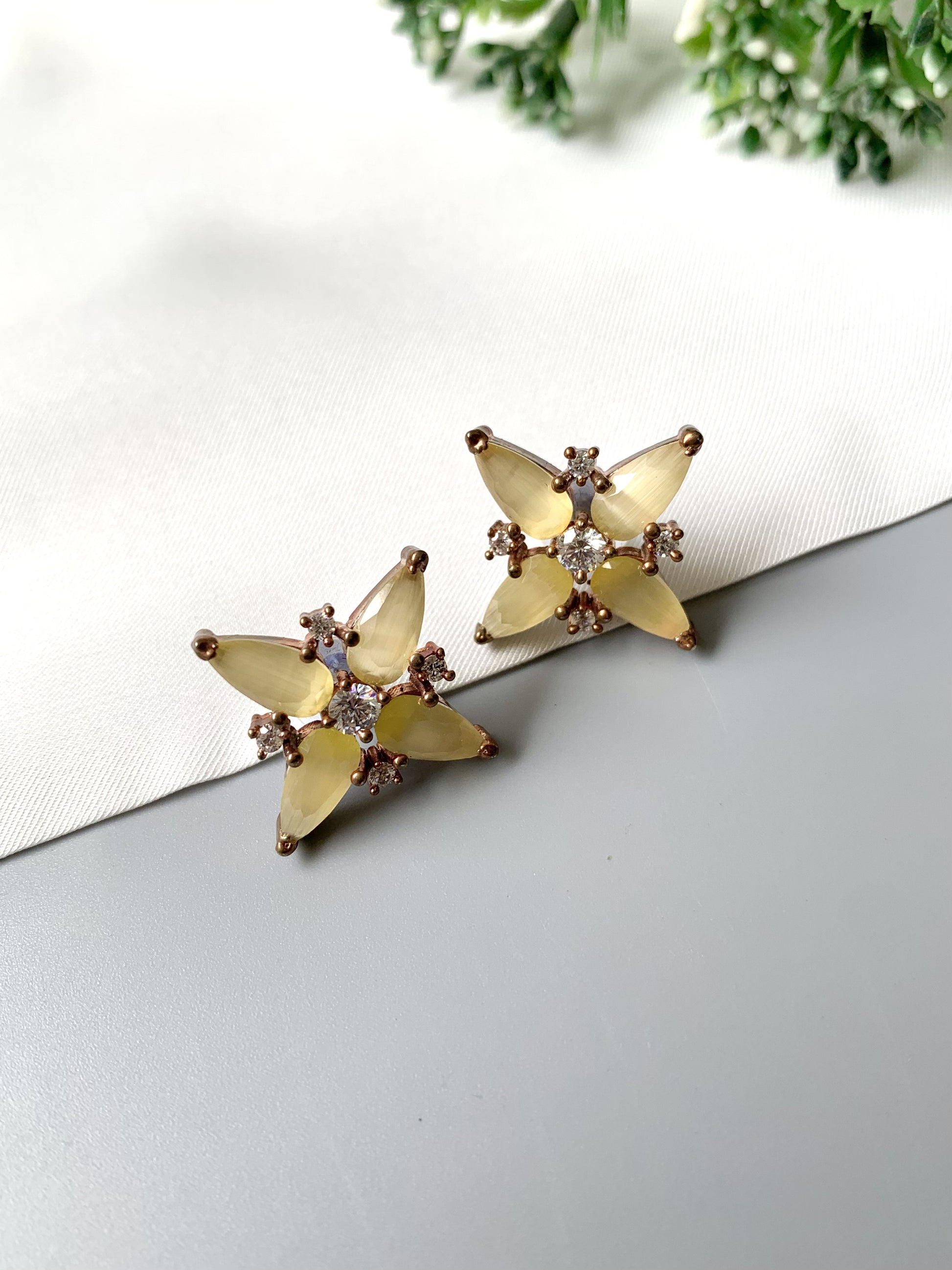 Closeup view of Zamal Jewels’ Sunlit Bloom Studs in yellow Onyx and American Diamonds