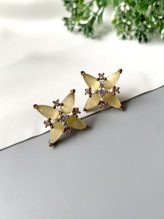 Handcrafted yellow floral stud earrings with semi-precious Onyx and American Diamonds in oxidized black gold polish