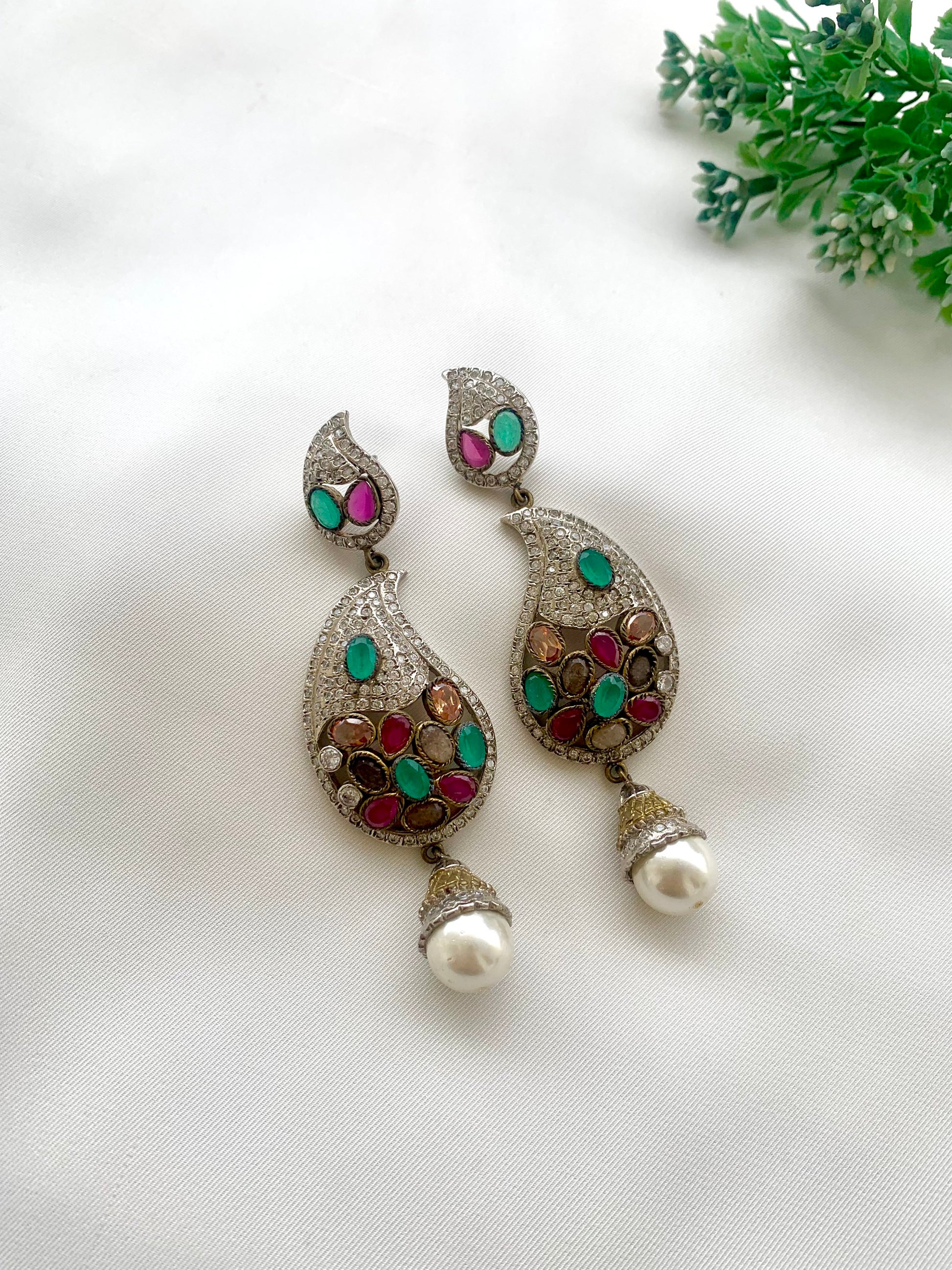 Vilde handcrafted rhodium plated Victorian finish earrings featuring American Diamonds, semi-precious Ruby, Emerald, Champagne, Nauratan gemstones, and Pearls