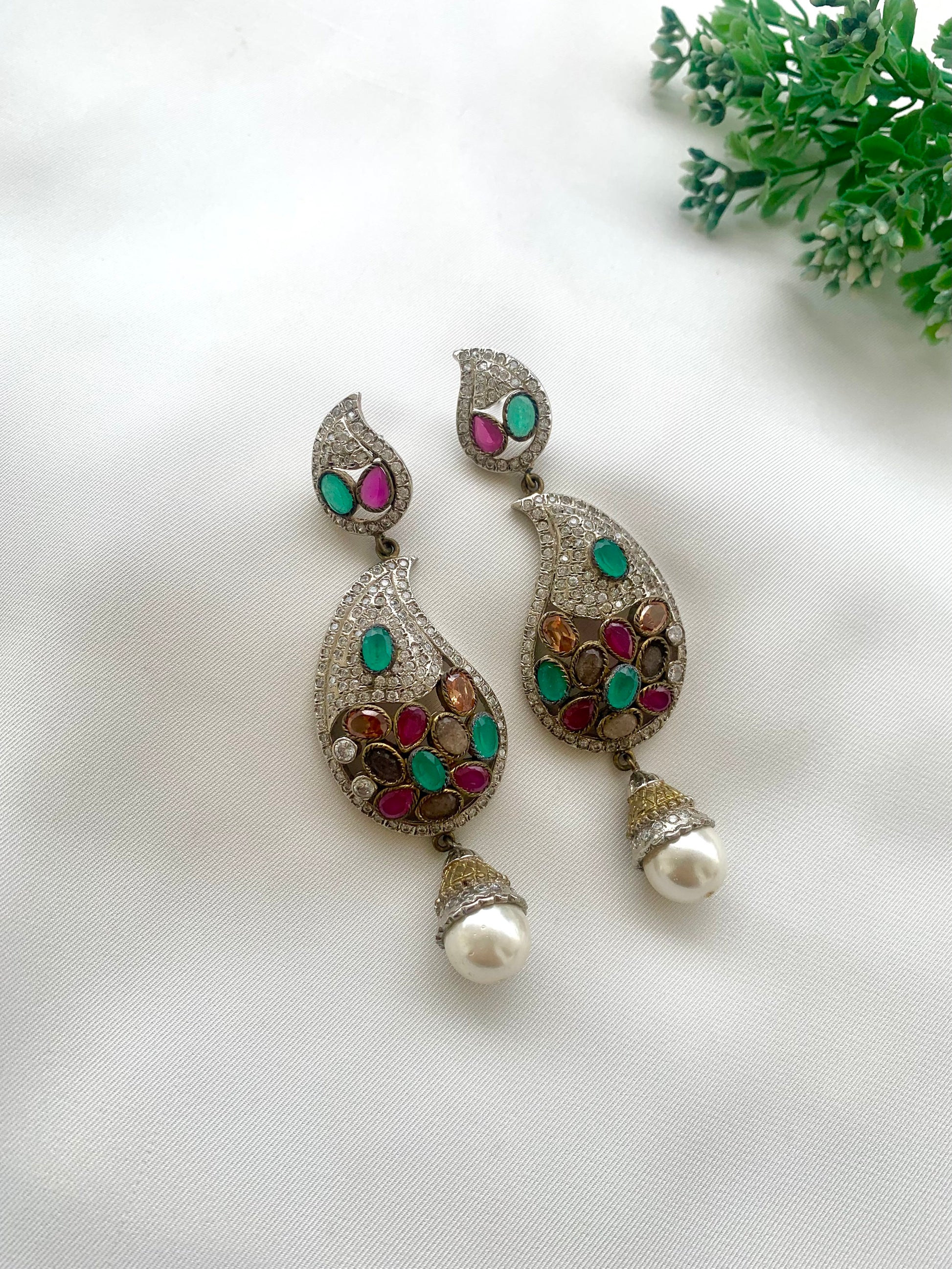 Vilde handcrafted rhodium plated Victorian finish earrings featuring American Diamonds, semi-precious Ruby, Emerald, Champagne, Nauratan gemstones, and Pearls
