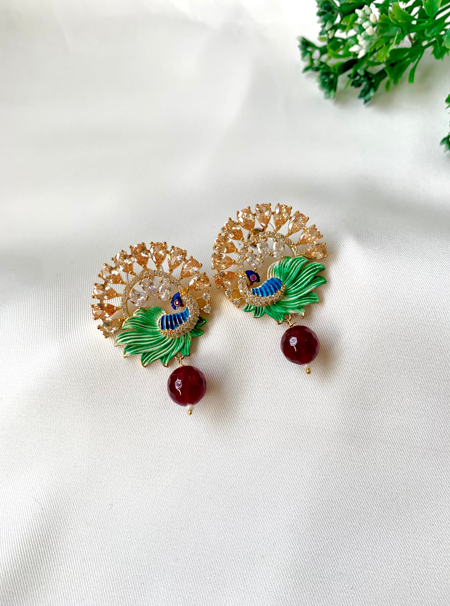 Hand crafted Vire Champagne peacock designer earrings in 22kt gold plating with American Diamonds, semi-precious champagne & ruby and hand-painted Meena