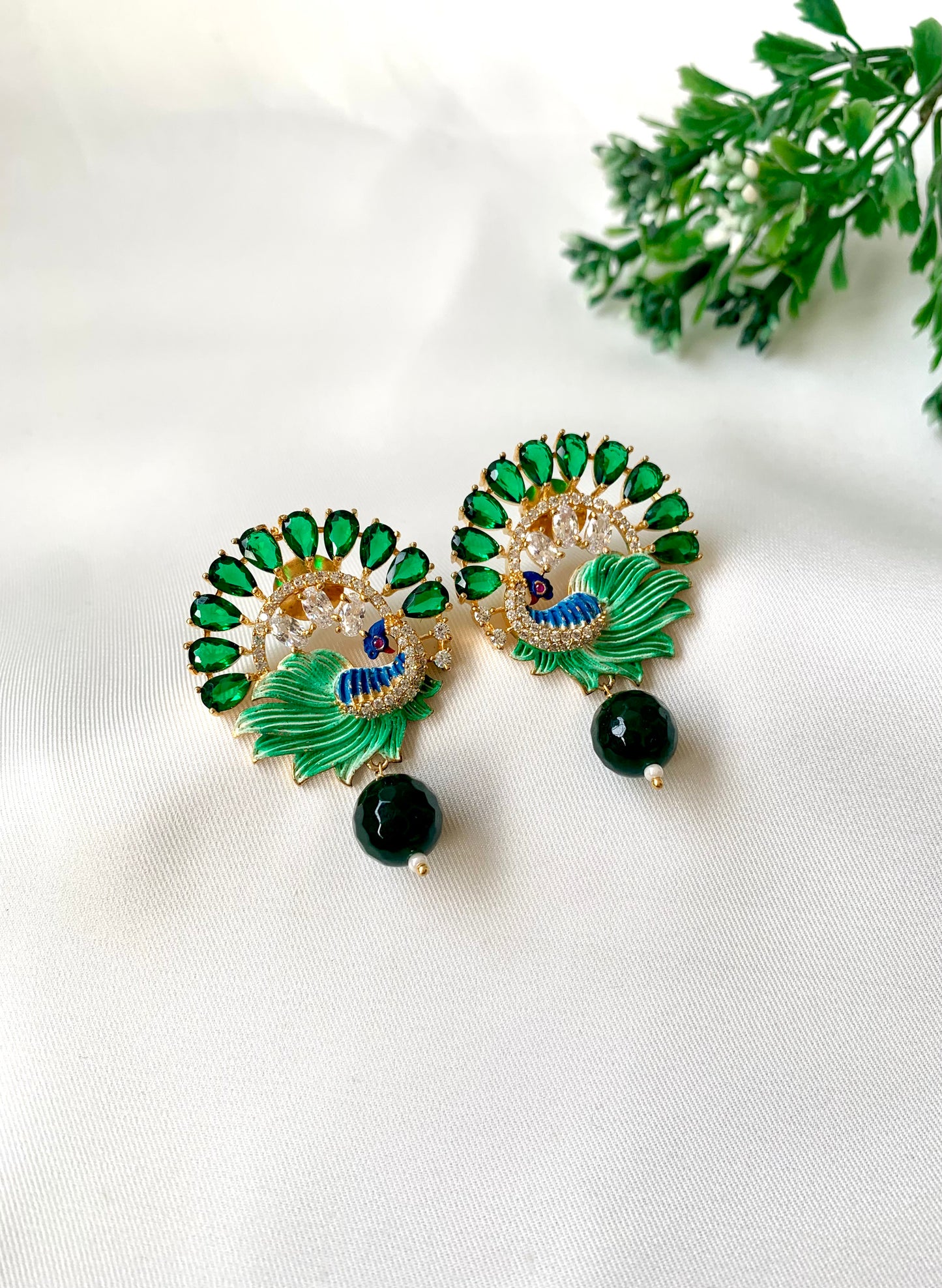 Hand crafted Vire Emerald peacock designer earrings in 22kt gold plating with American Diamonds, semi-precious emerald and hand-painted Meena