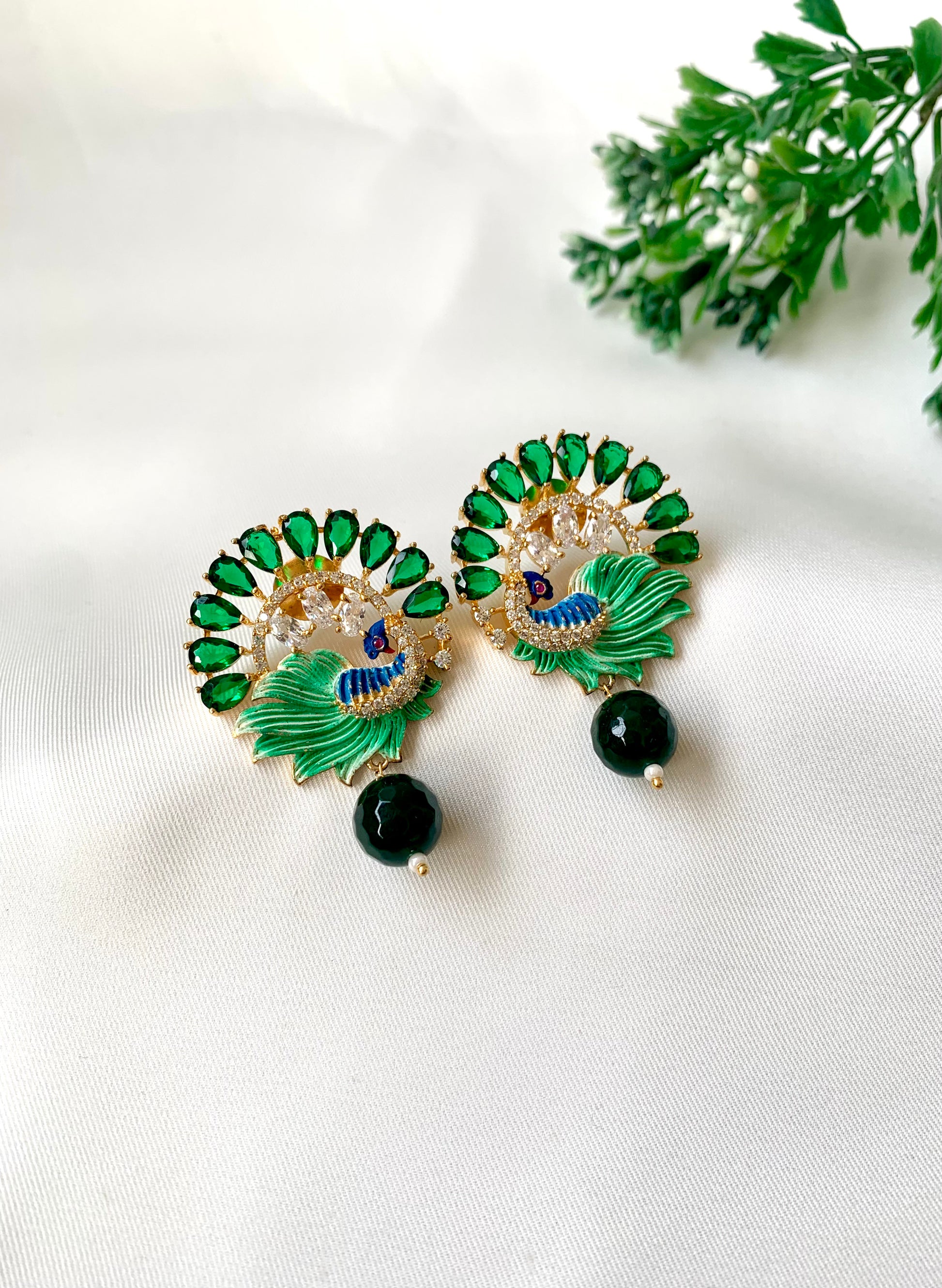 Hand crafted Vire Emerald peacock designer earrings in 22kt gold plating with American Diamonds, semi-precious emerald and hand-painted Meena