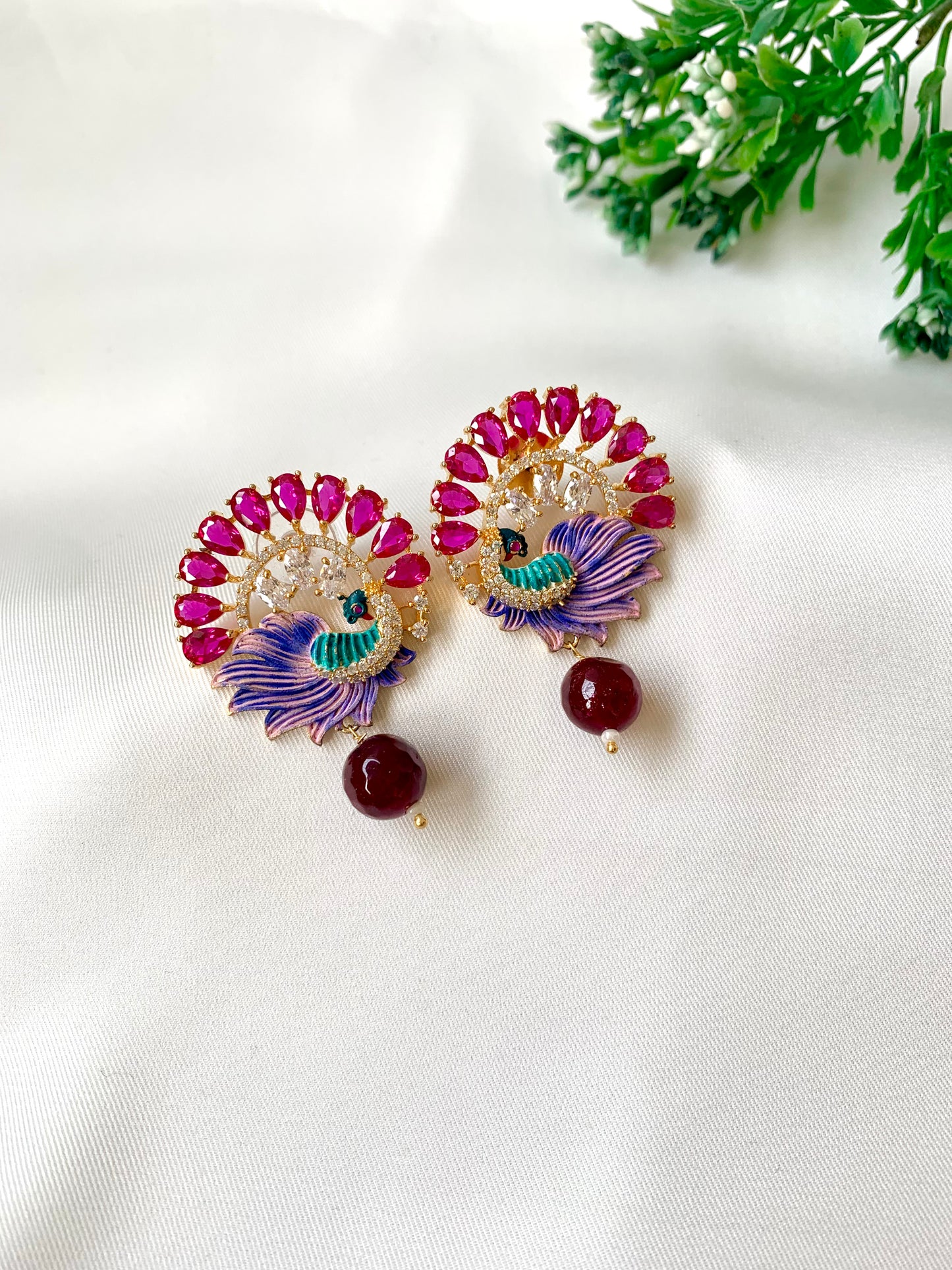 Hand crafted Vire Ruby peacock designer earrings in 22kt gold plating with American Diamonds, semi-precious ruby and hand-painted Meena