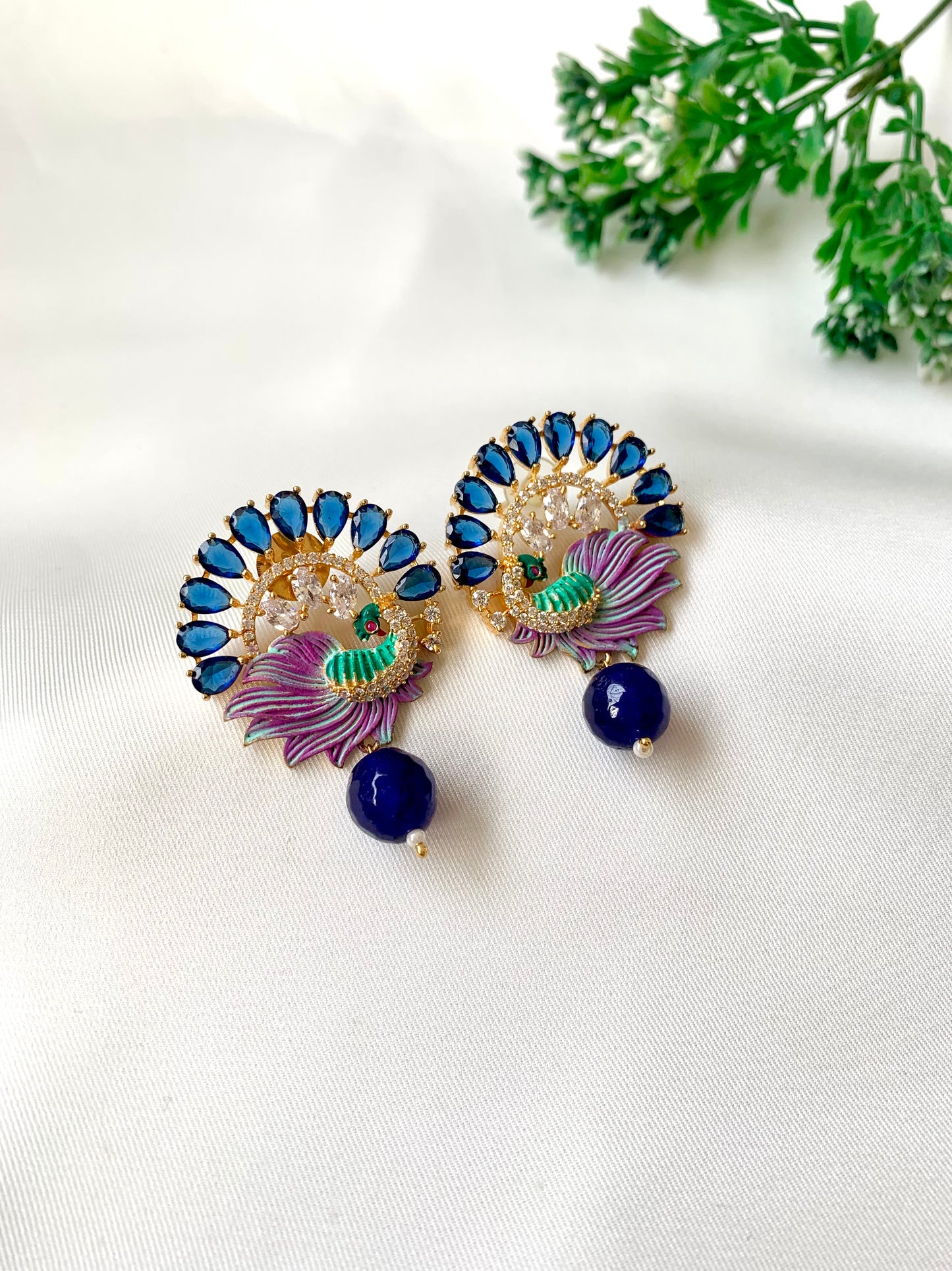 Hand crafted Vire Sapphire peacock designer earrings in 22kt gold plating with American Diamonds, semi-precious sapphire and hand-painted Meena