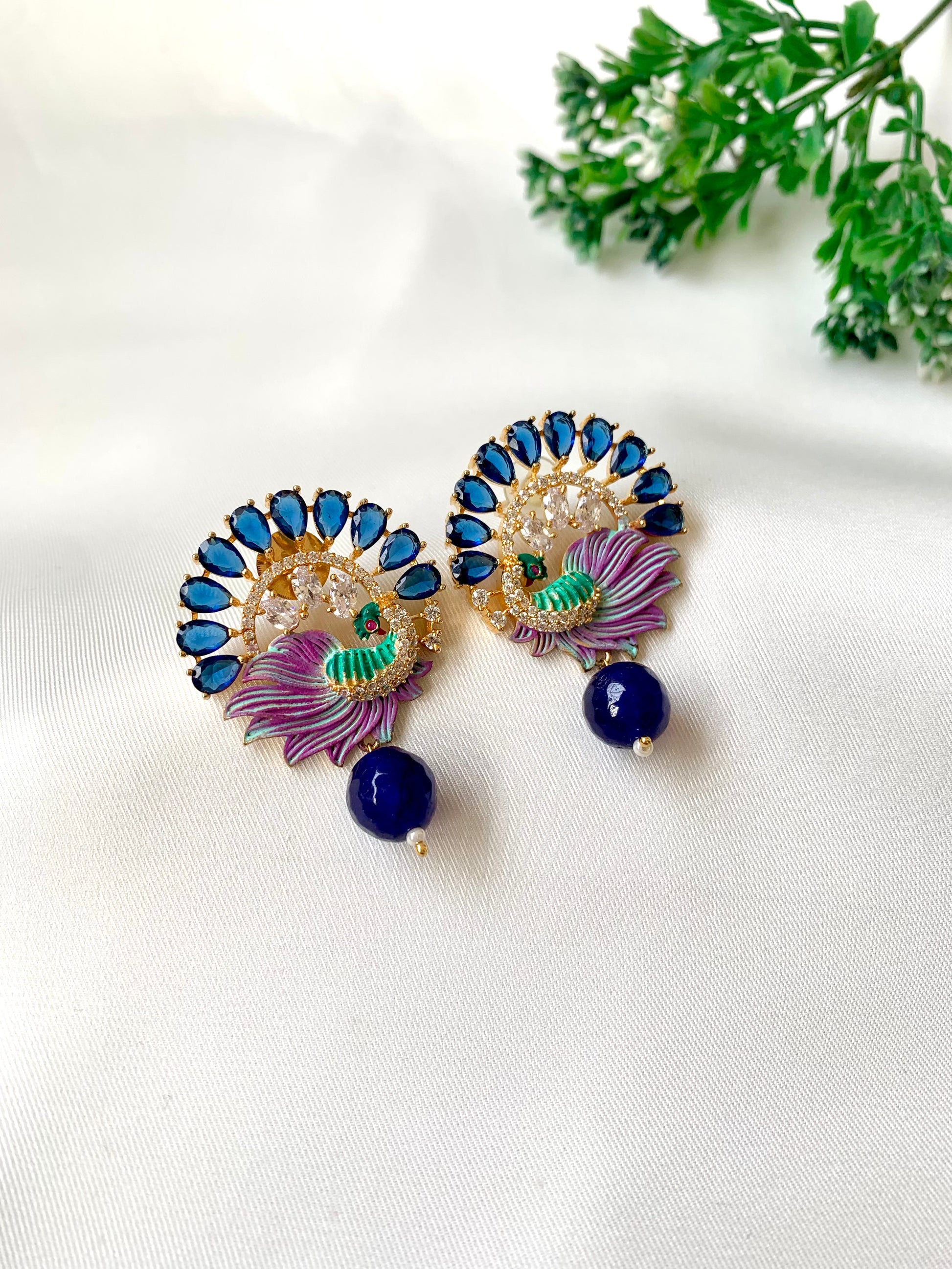 Hand crafted Vire Sapphire peacock designer earrings in 22kt gold plating with American Diamonds, semi-precious sapphire and hand-painted Meena