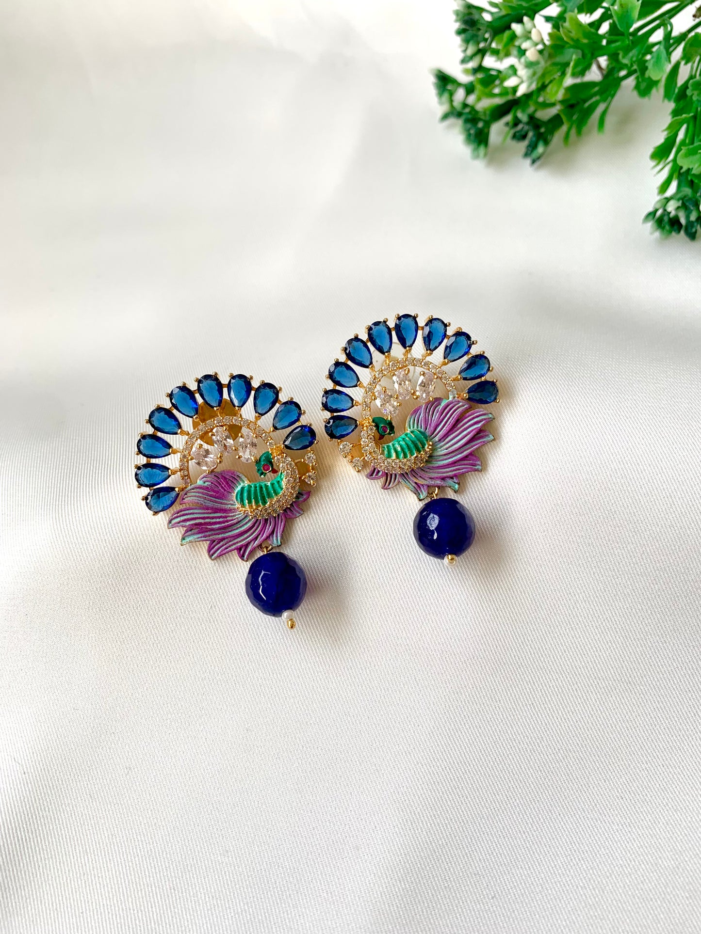 Hand crafted Vire Sapphire peacock designer earrings in 22kt gold plating with American Diamonds, semi-precious sapphire and hand-painted Meena