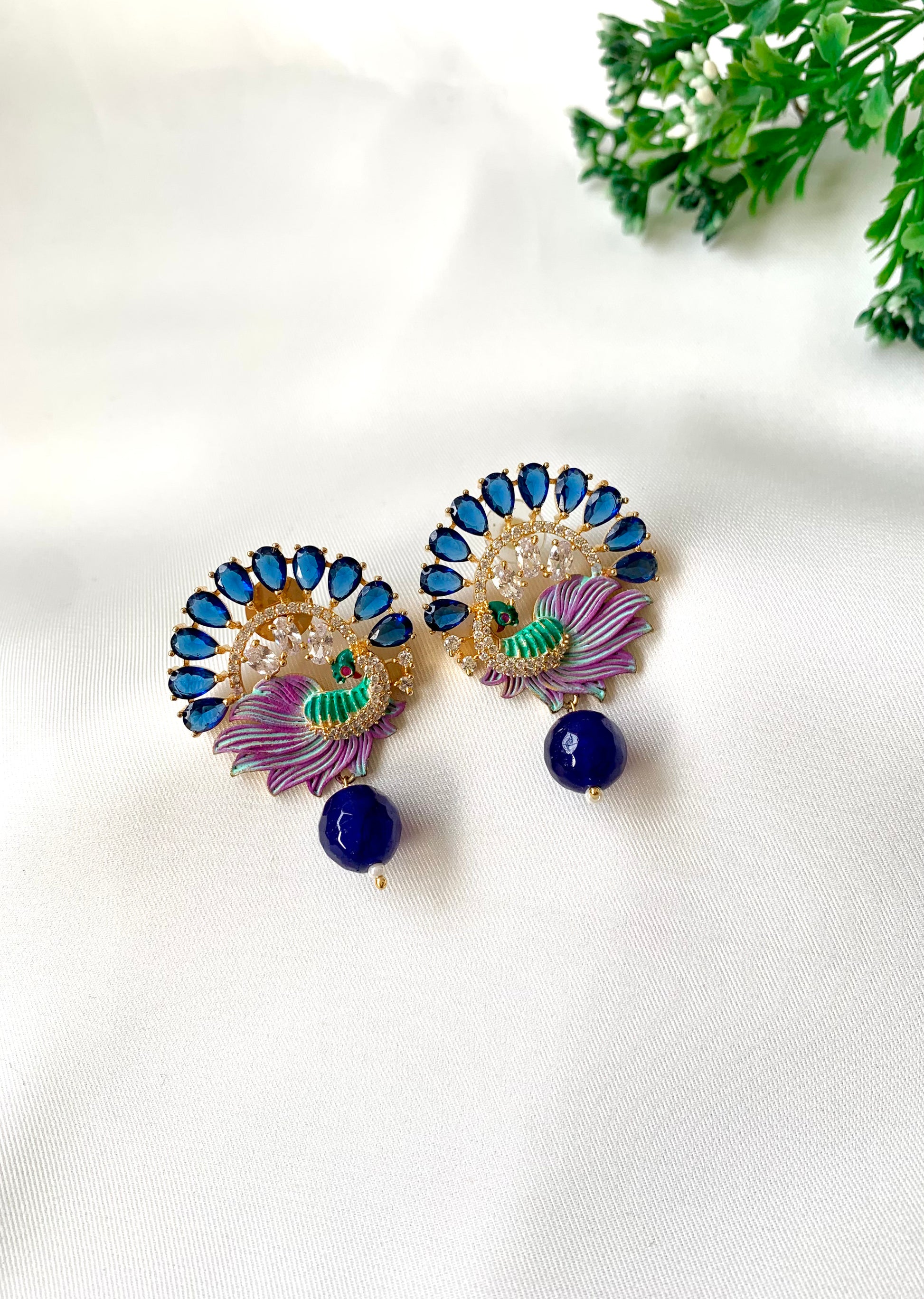 Hand crafted Vire Sapphire peacock designer earrings in 22kt gold plating with American Diamonds, semi-precious sapphire and hand-painted Meena