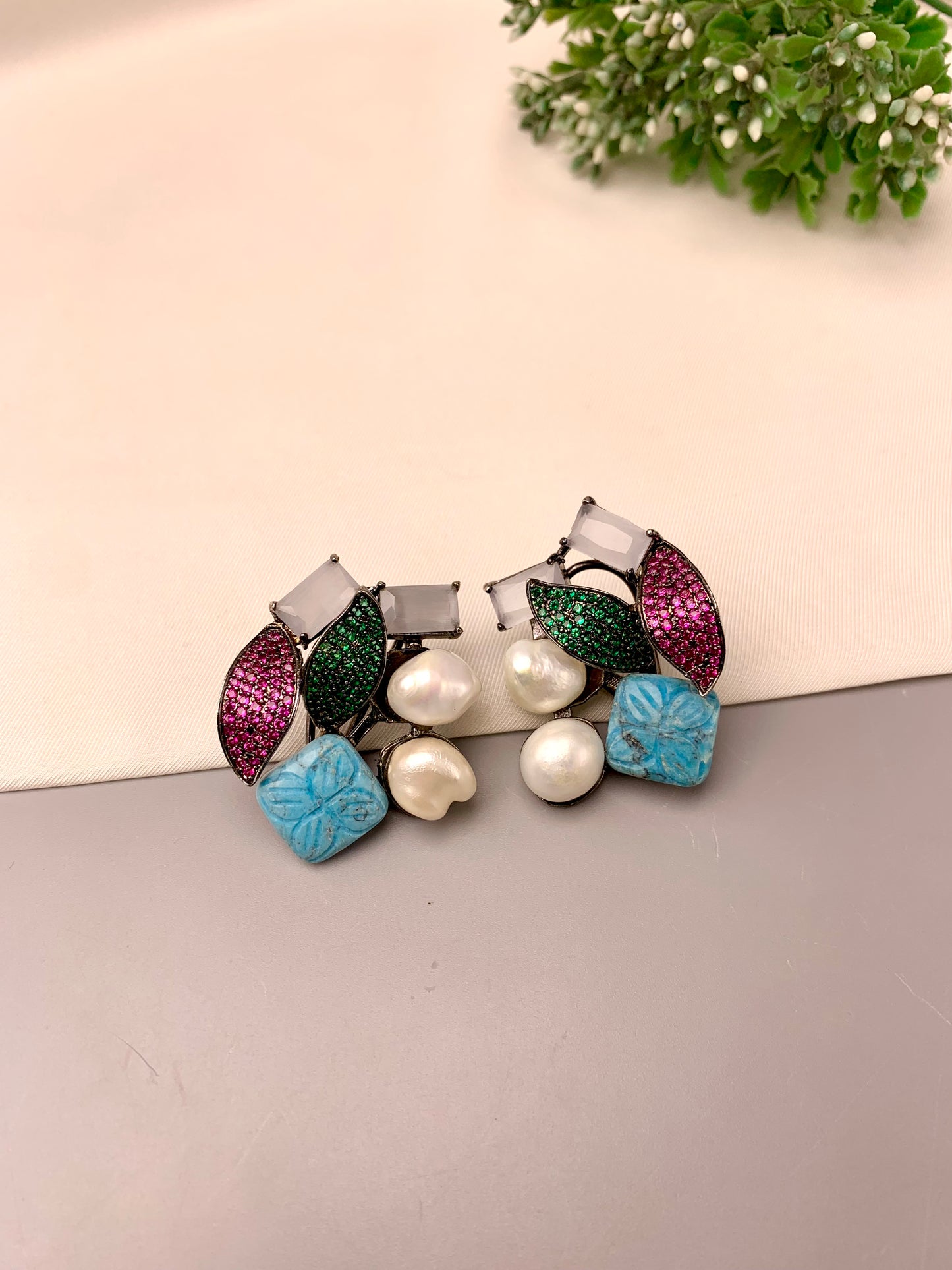 Visha handcrafted rhodium plated oxidized studs featuring real Baroque Pearls, hand-carved Feroza, pearls, and genuine Emerald and Ruby Swarovski crystals