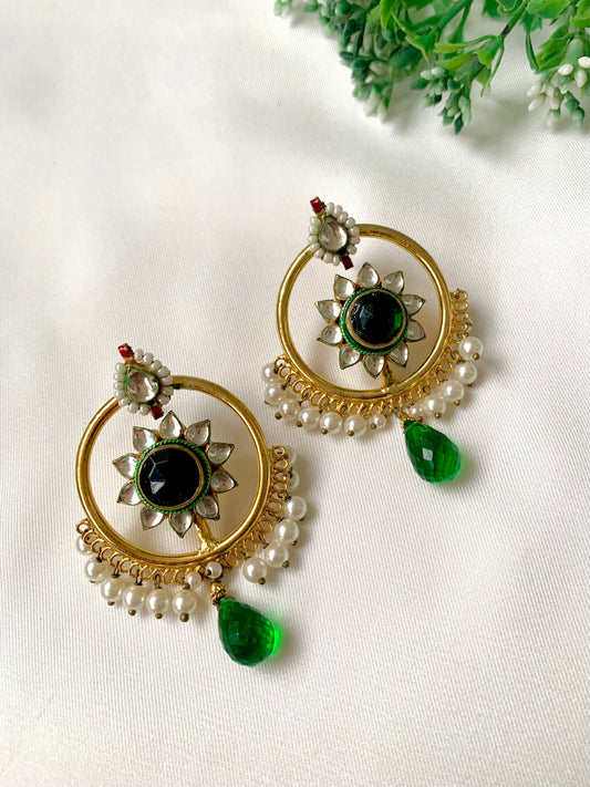 22kt Gold Plated handcrafted earrings with Pachi Kundan, semi-precious emerald centre, pearl detailing, and emerald teardrop accents displayed on a white fabric background.