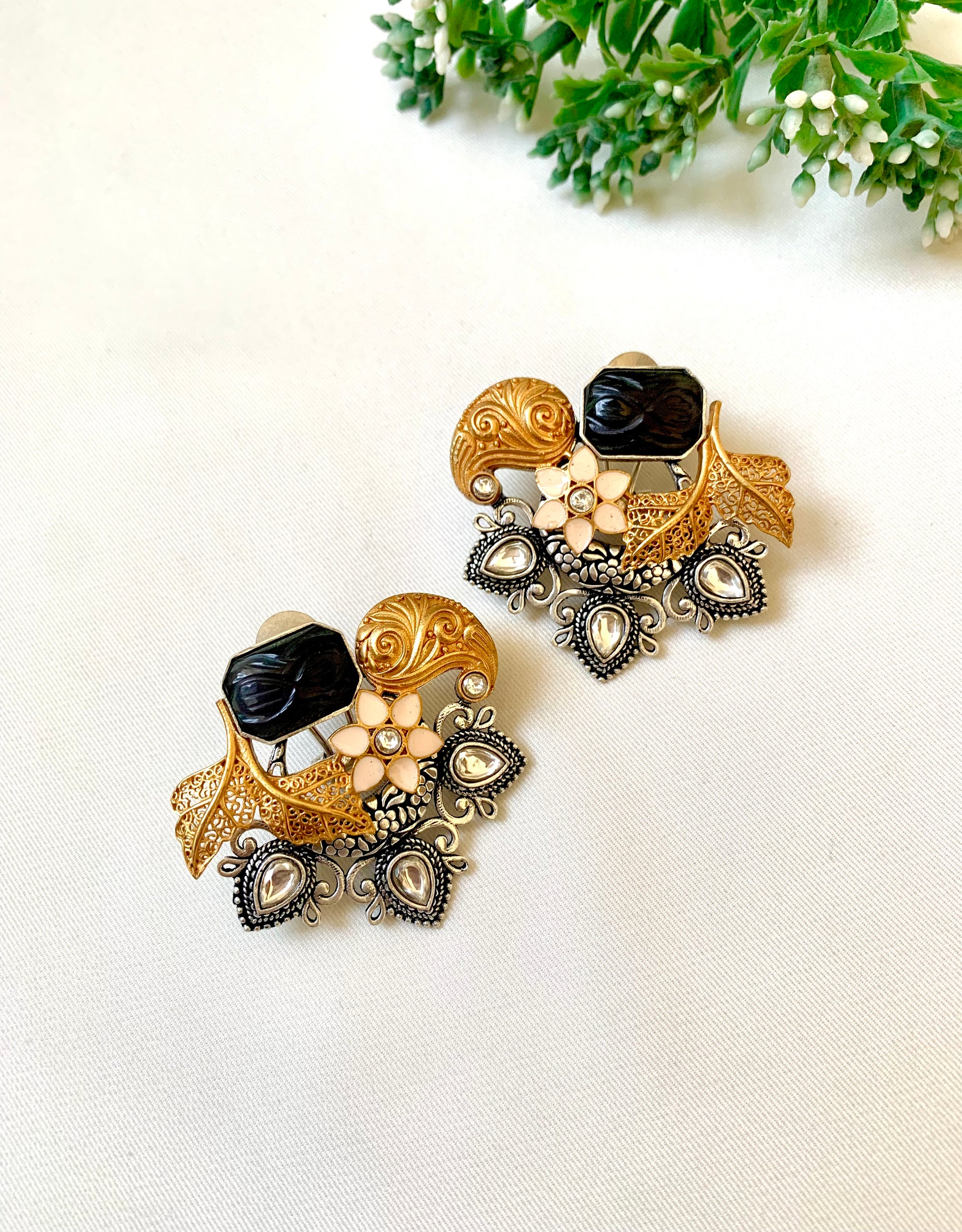 Close-up of Jesiya black onyx Meenakari studs showing filigree leaves and oxidized detailing — Zamal Jewels Pakistan