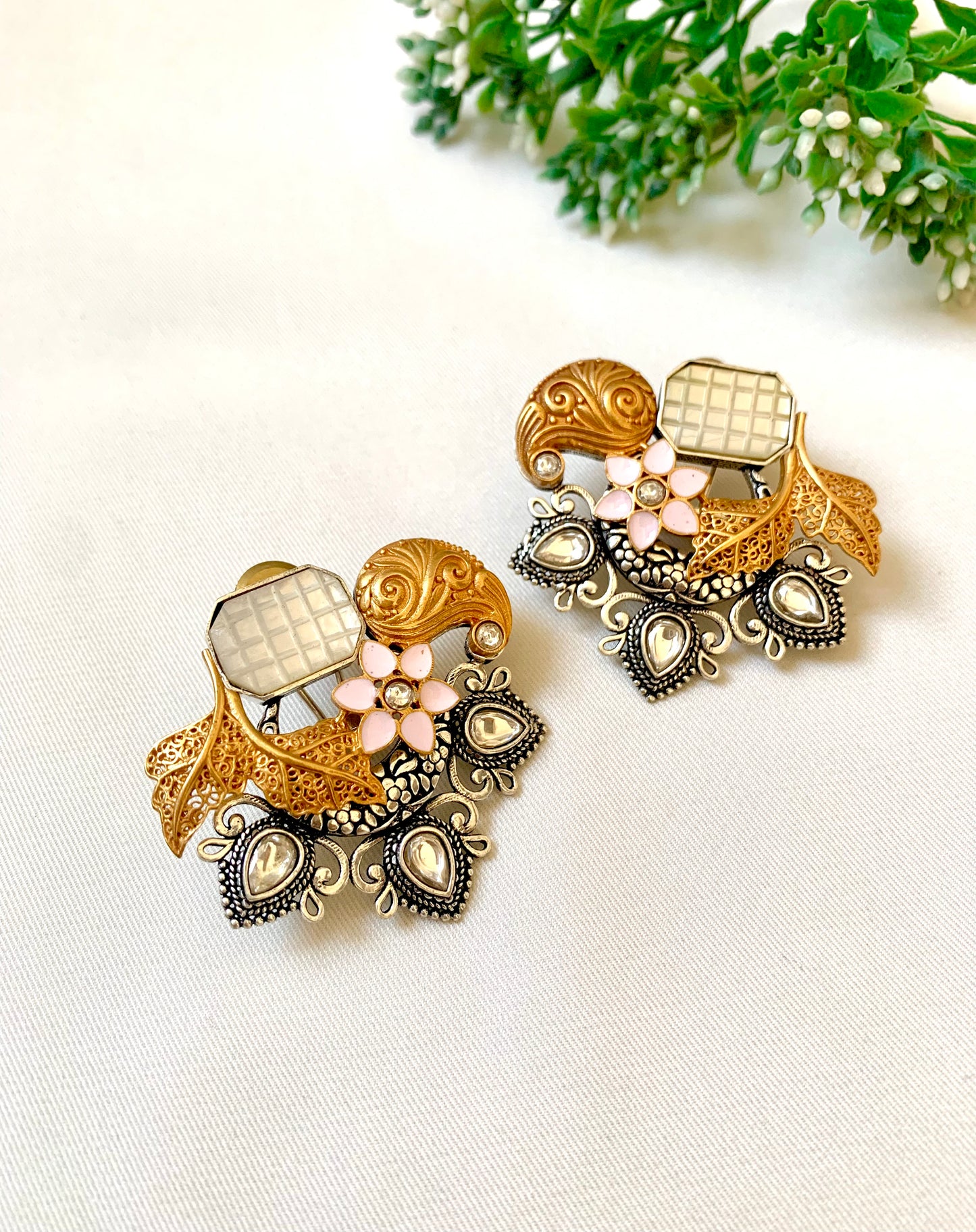 Asymmetric mother of pearl Meenakari studs showing filigree leaves and oxidized detailing — Zamal Jewels Pakistan