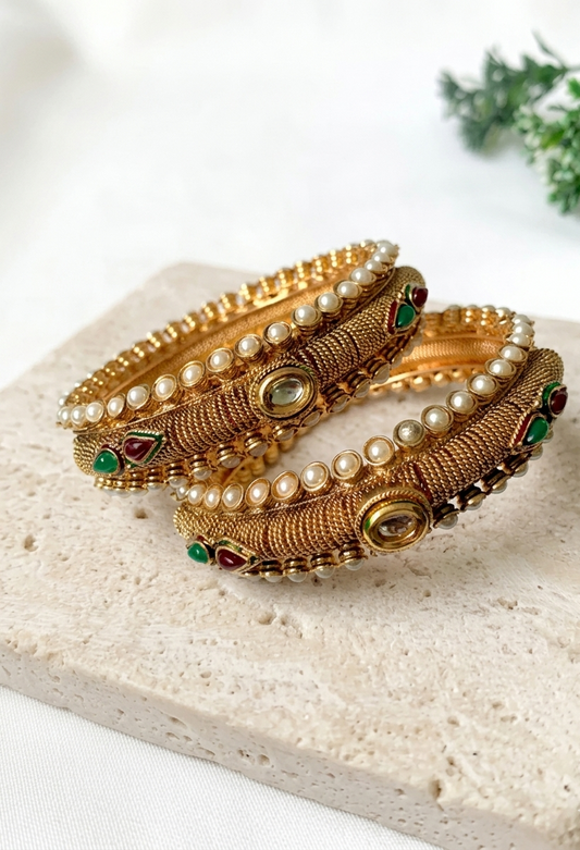 Pair of handcrafted 22kt gold plated openable screw bangles with Kundan, semi-precious pearls, ruby, and emerald stones