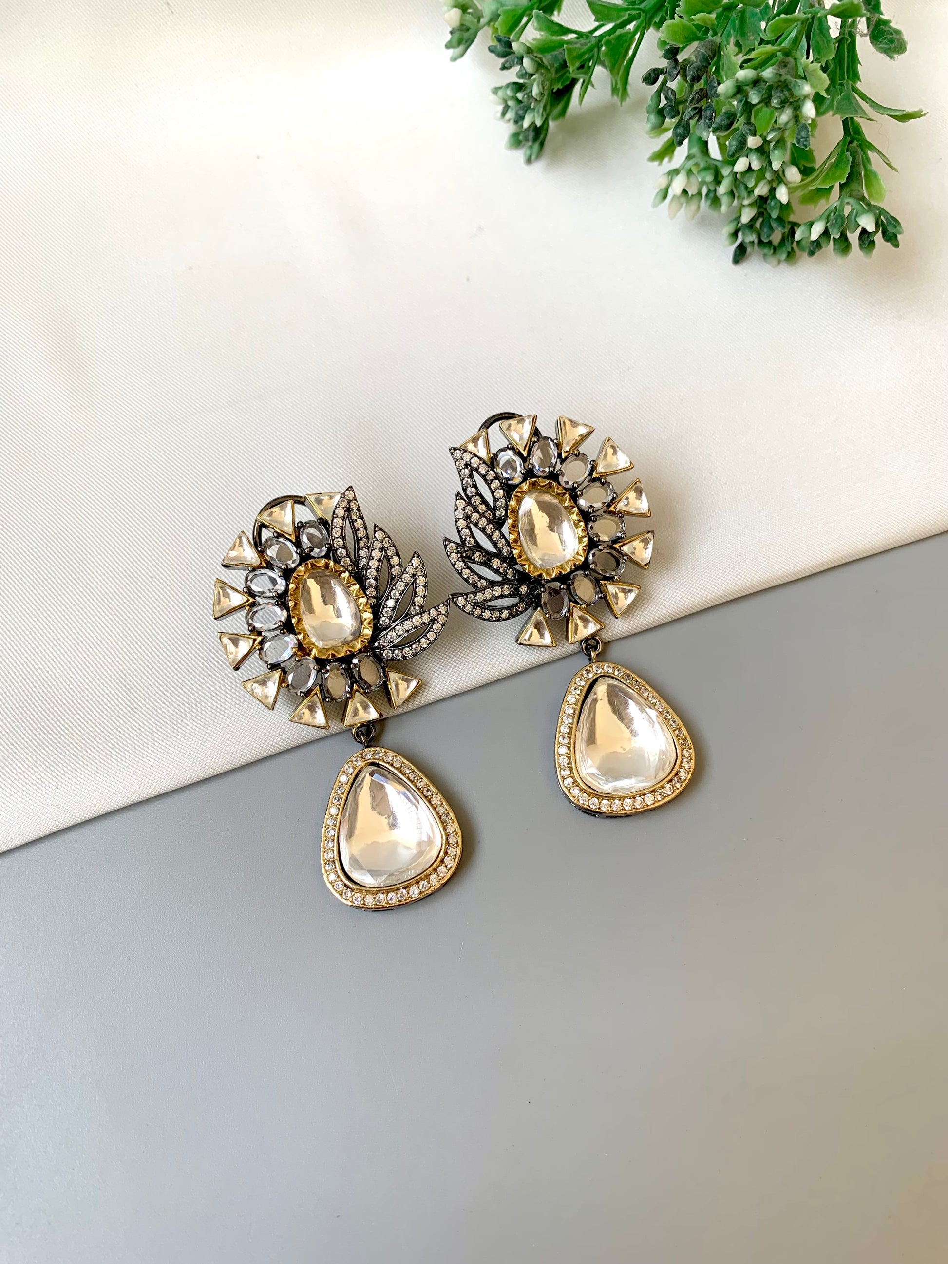 Afsana handcrafted signature earrings in gold and rhodium plating with oxidized finish featuring American diamonds and polki kundan