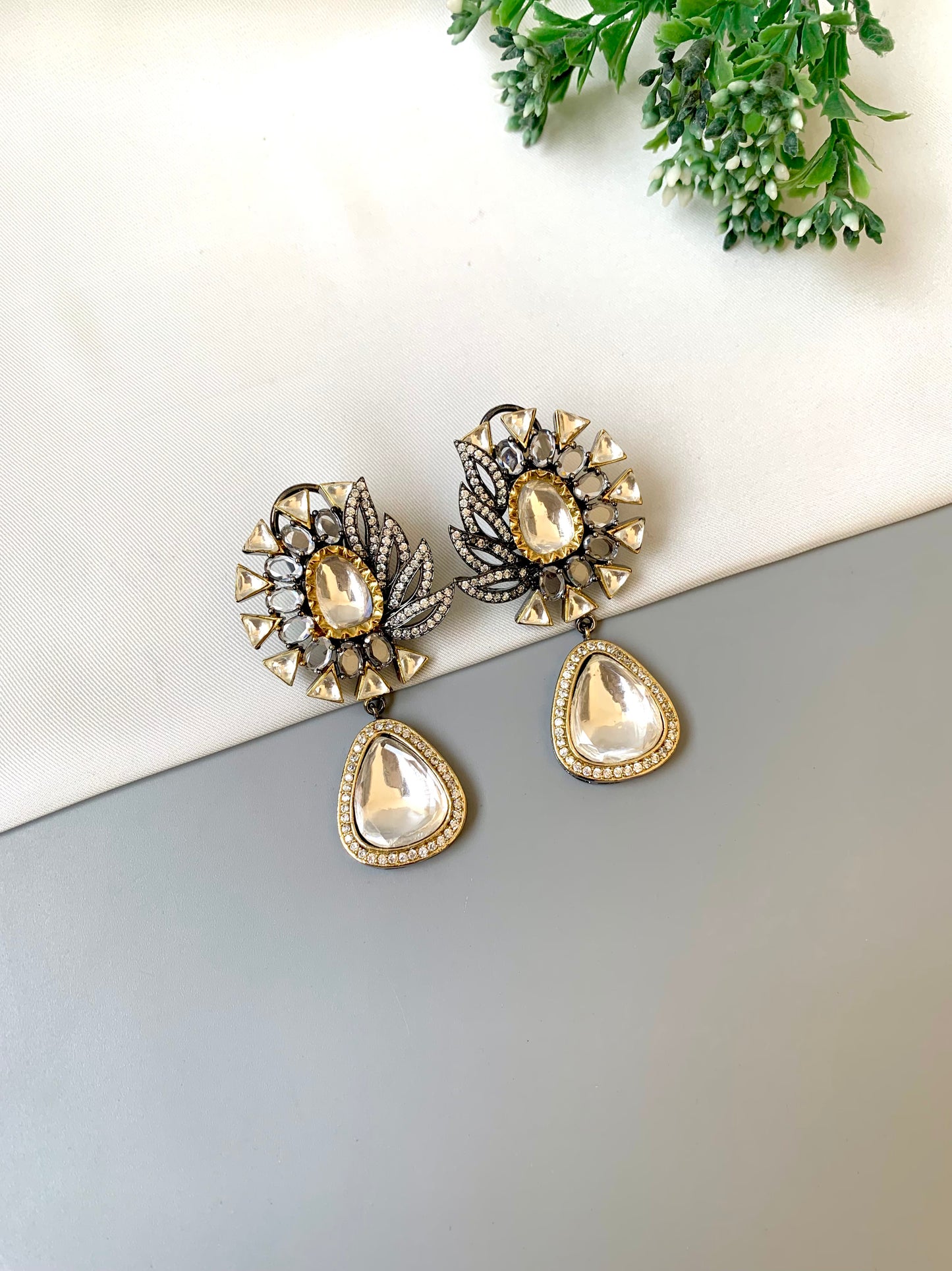 Afsana handcrafted signature earrings in gold and rhodium plating with oxidized finish featuring American diamonds and polki kundan