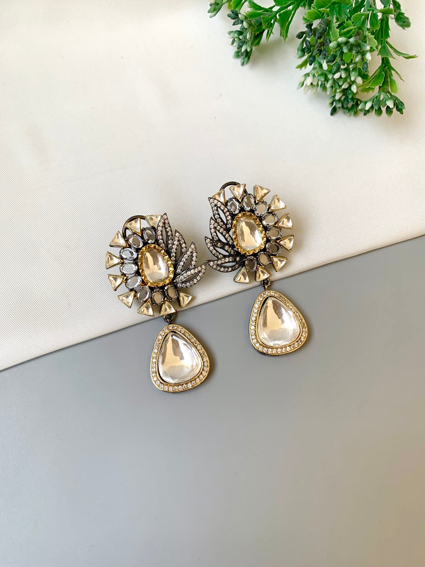 Afsana handcrafted signature earrings in gold and rhodium plating with oxidized finish featuring American diamonds and polki kundan
