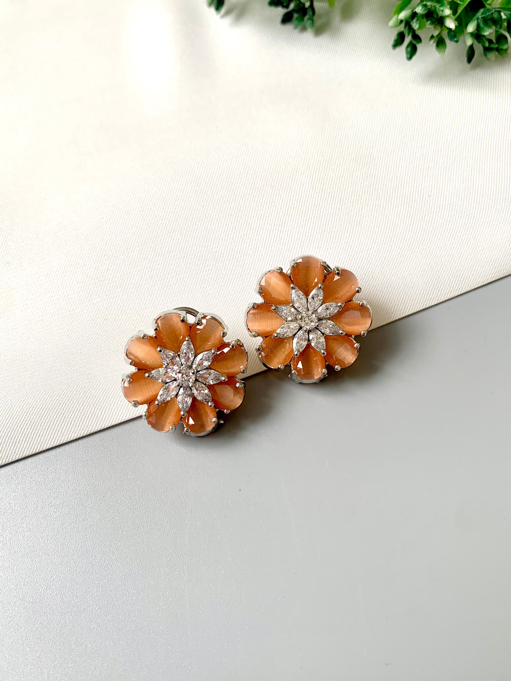 Rhodium plated floral stud earrings featuring semi-precious amber onyx petals and high-quality American Diamonds from Zamal Jewels