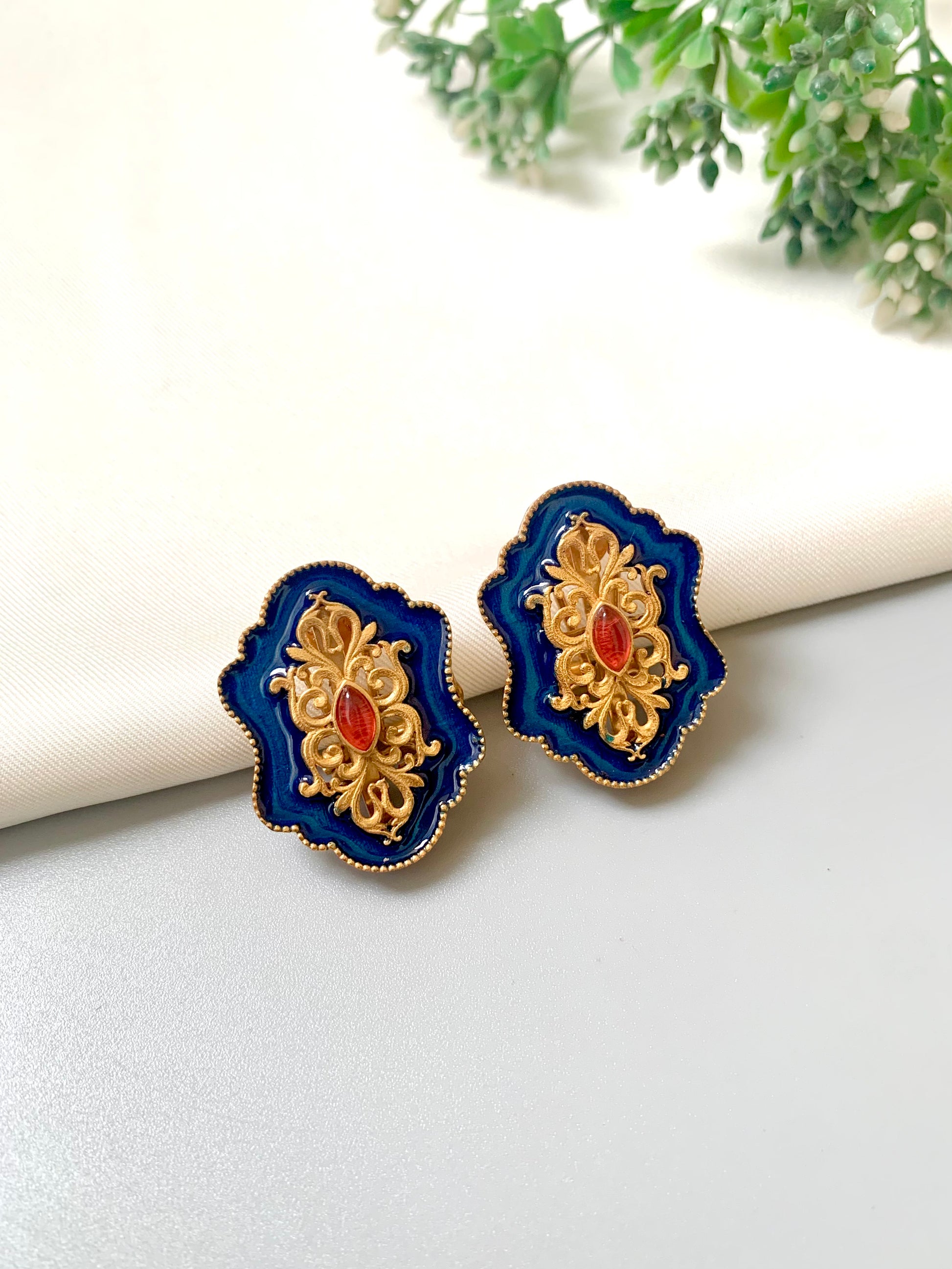 Handcrafted sapphire blue Meena studs with 22kt gold plating and Polki Kundan detail from Zamal Jewels.