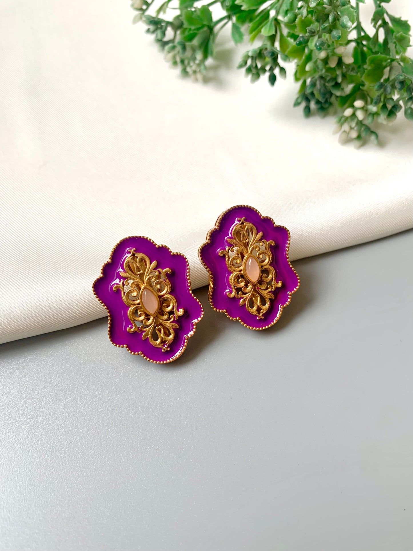 22kt gold plated Anisa Studs featuring purple enamel detailing and high-quality gemstones
