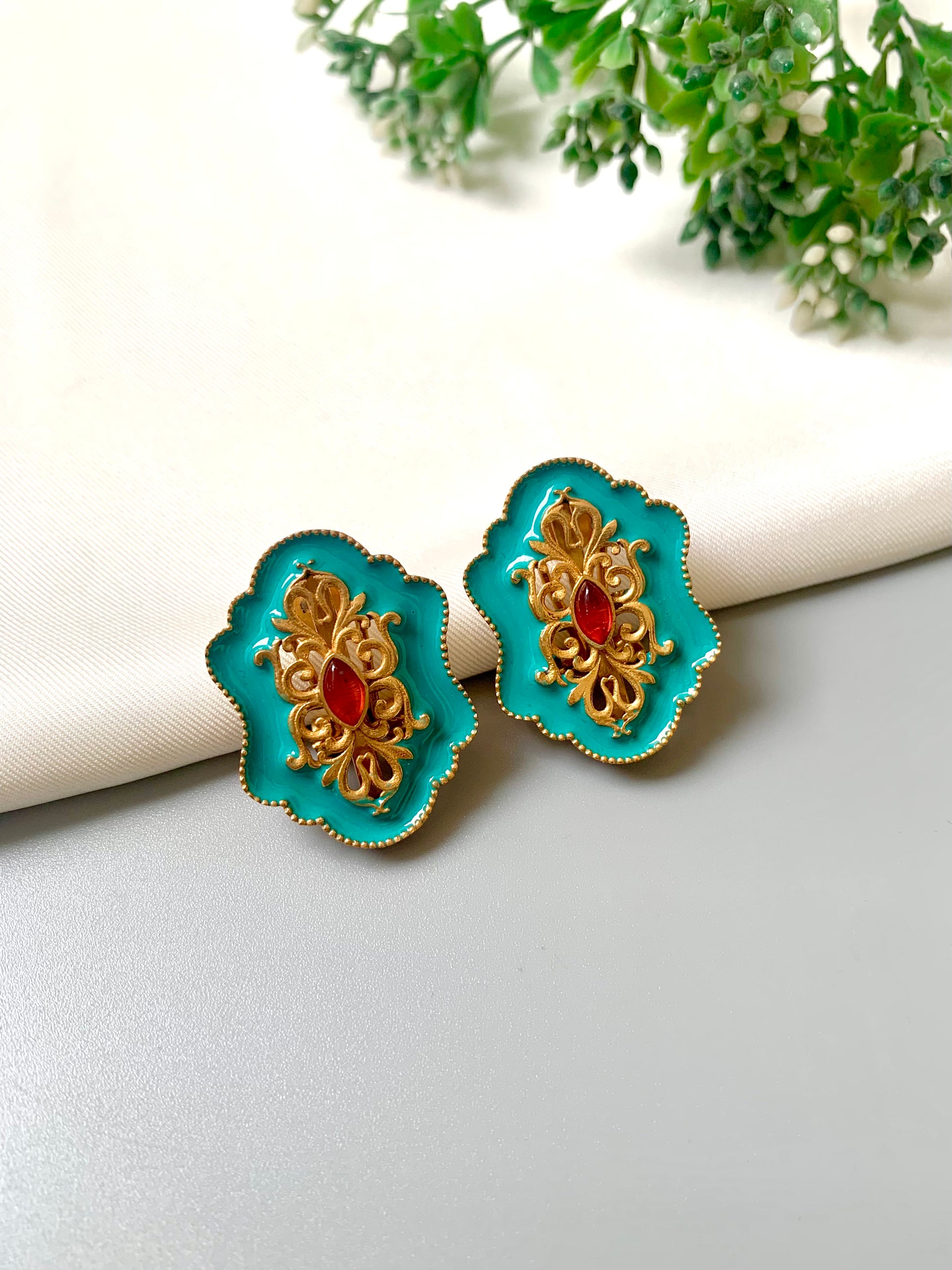 Handcrafted Anisa Stud earrings in Ferozi with 22kt gold plating, high-quality Polki Kundan, and hand-painted Meena work by Zamal Jewels.