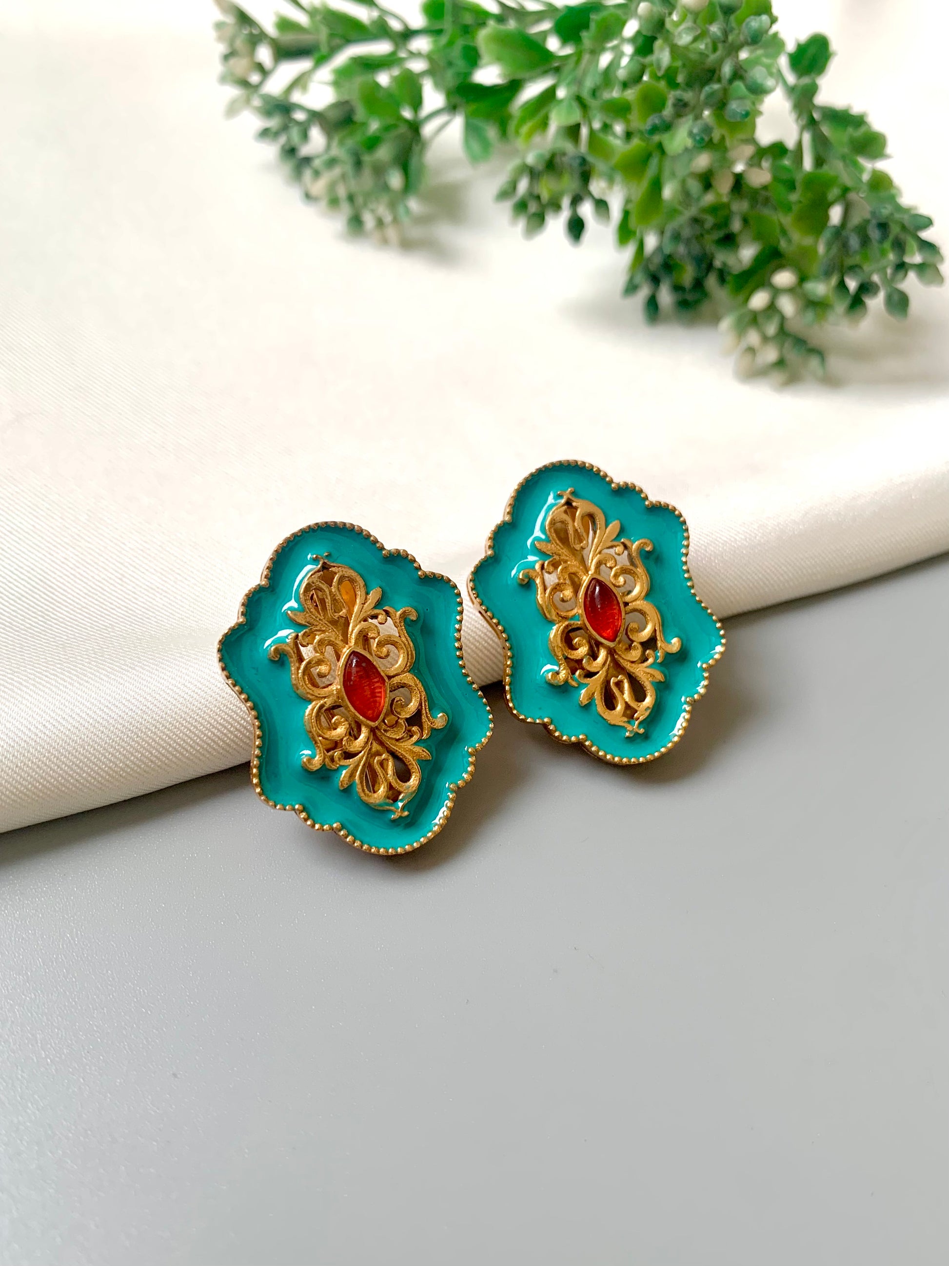 Handcrafted Anisa Stud earrings in Ferozi with 22kt gold plating, high-quality Polki Kundan, and hand-painted Meena work by Zamal Jewels.