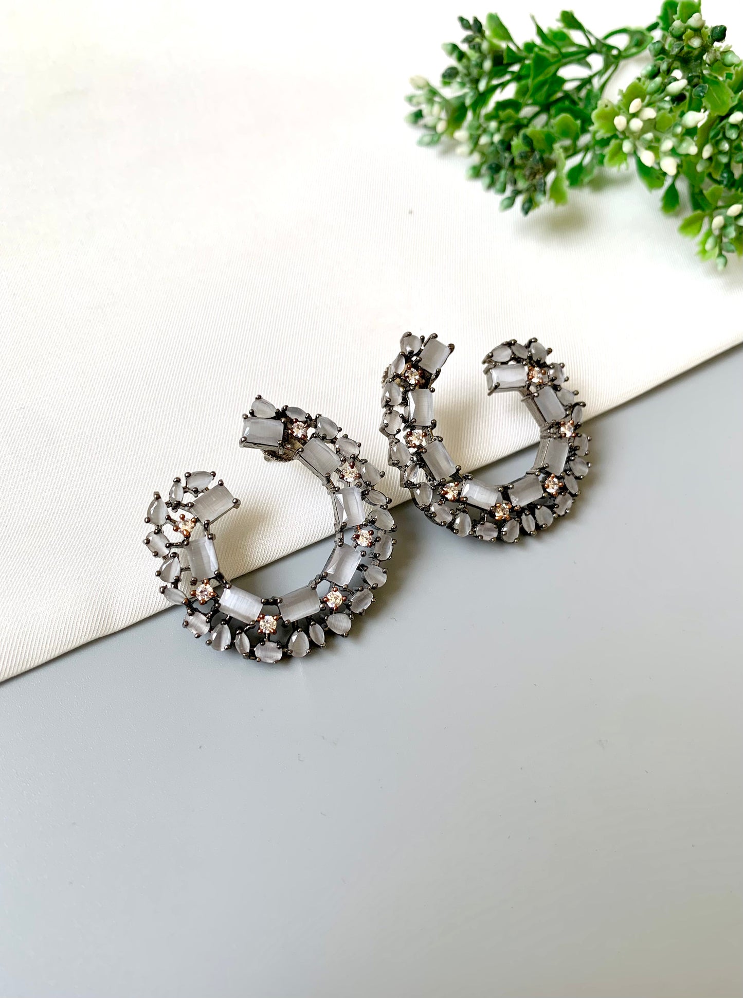 Side view of Arden hoop earrings showcasing rhodium finish and shimmering stonework with onyx and American Diamonds