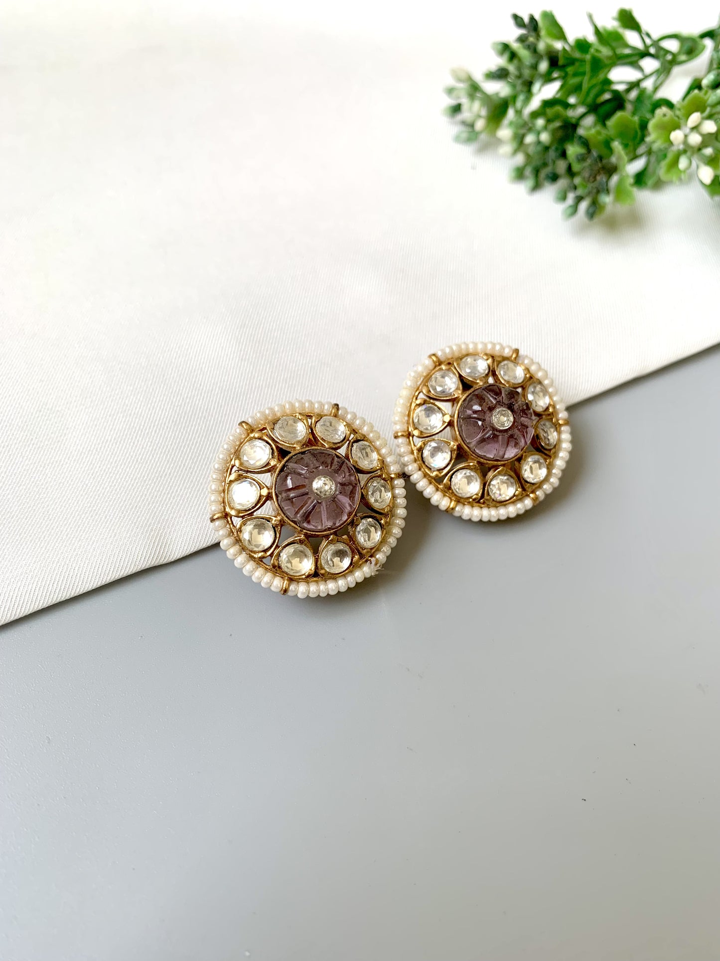 Handcrafted Ariya Studs featuring carved amethyst and Polki Kundan stones, bordered with delicate pearls