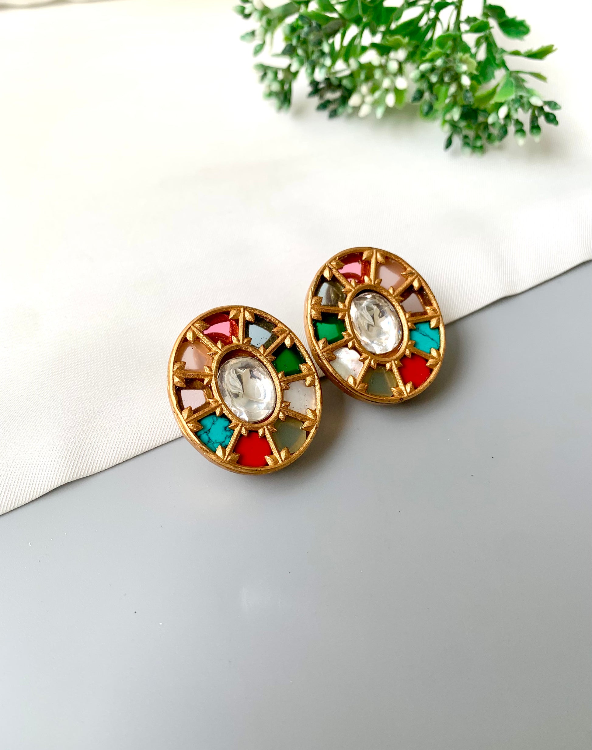 Close-up of Asmita Multi handcrafted studs featuring Ruby, Feroza, Coral, and more in antique gold finish.