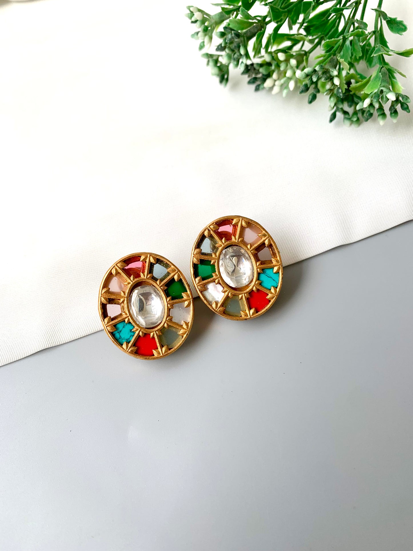 Front view of Asmita Multi earrings with colorful semi-precious stones and central Polki Kundan in Victorian gold.