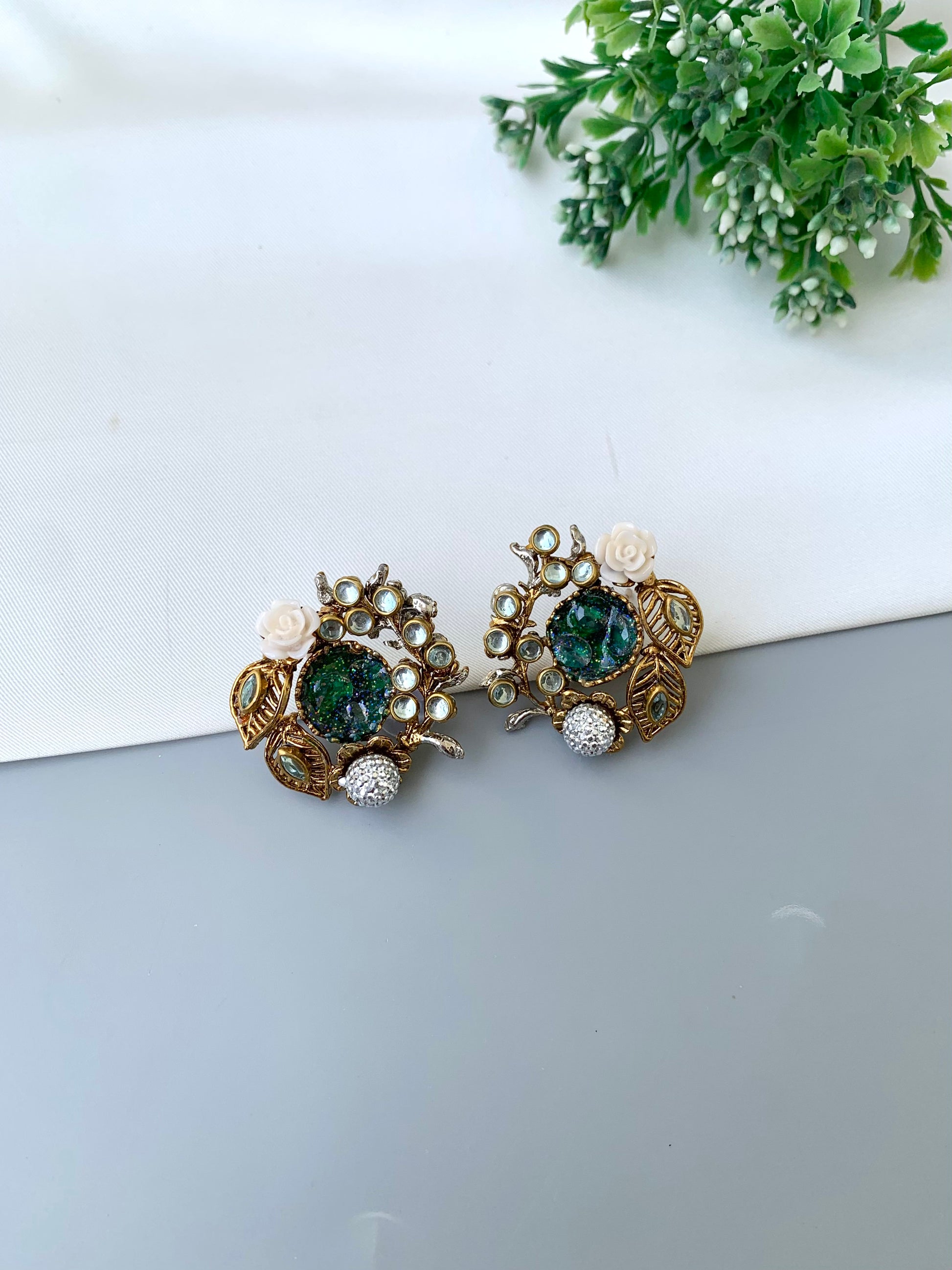 Athena emerald kundan earrings in gold plating with American diamonds and gemstone detailing