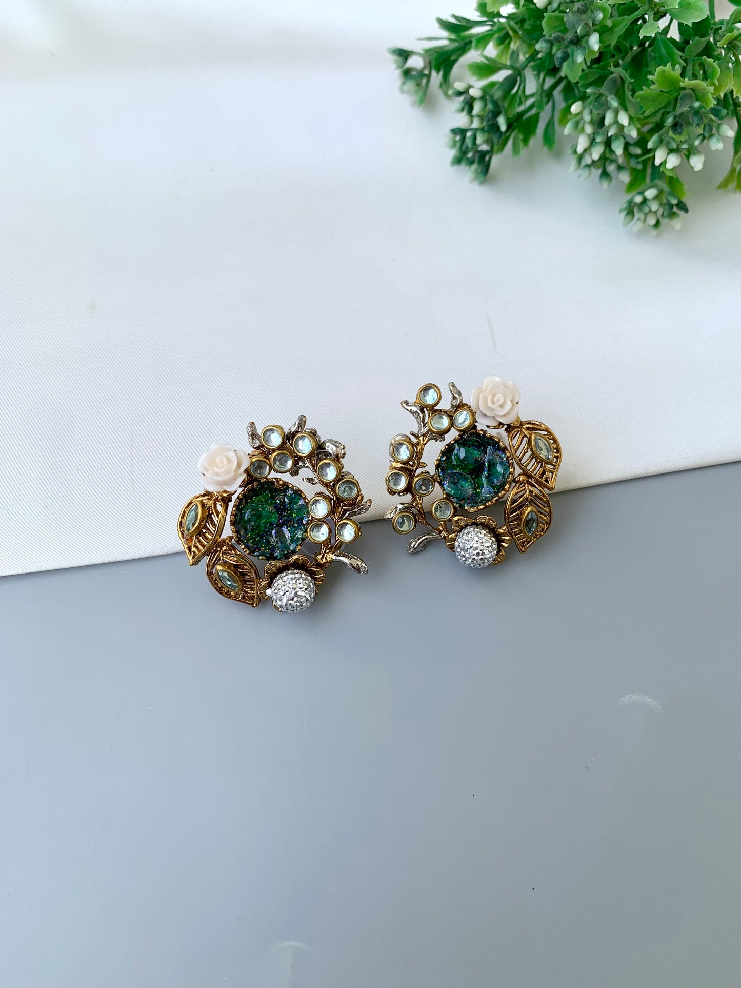 Athena emerald kundan earrings in gold plating with American diamonds and gemstone detailing
